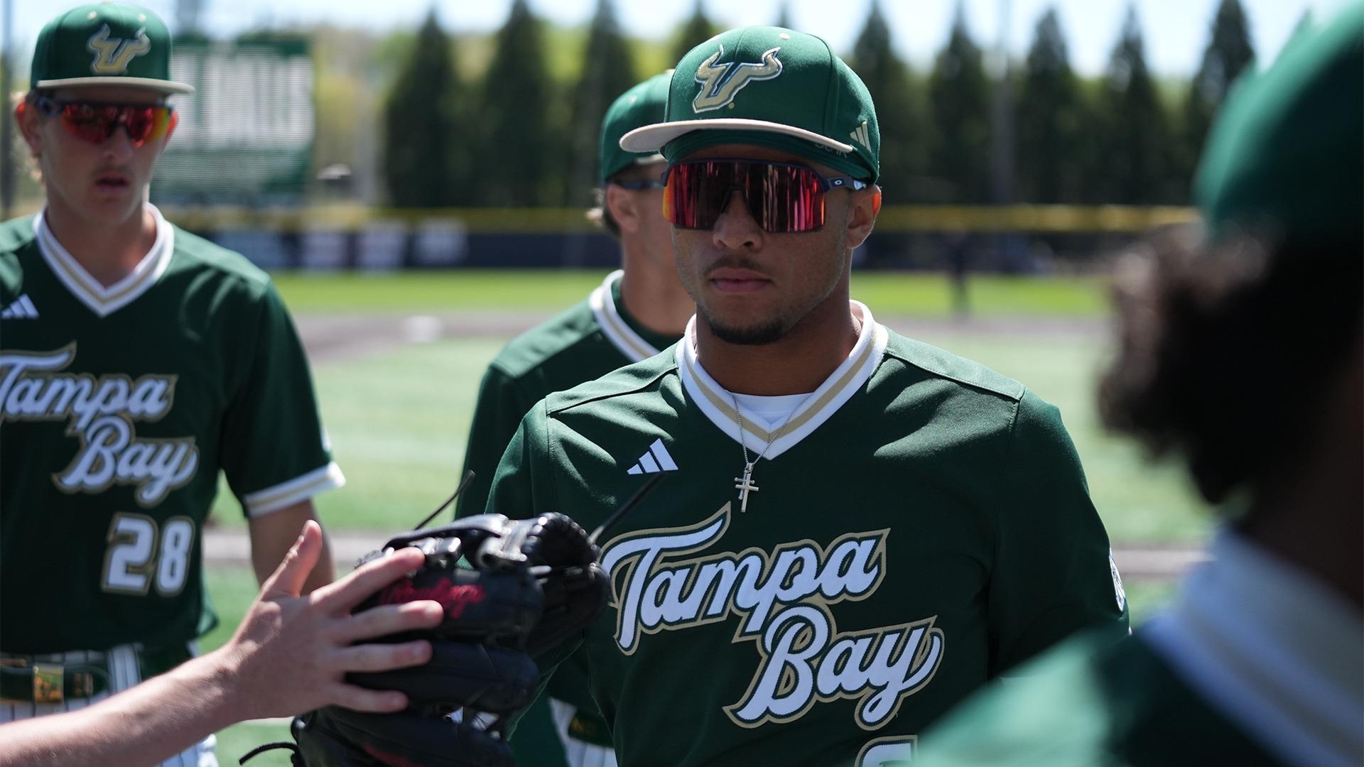 Jacob Green returning to the dugout after a half inning in the field.