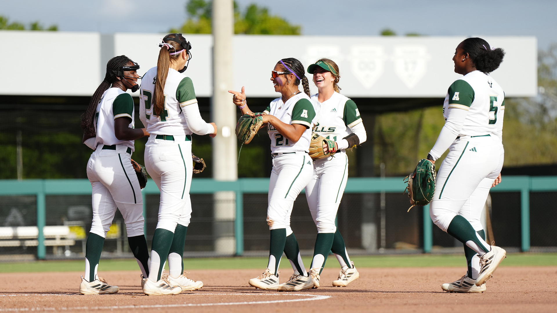 Softball infield celebration after a big play against Wichita State