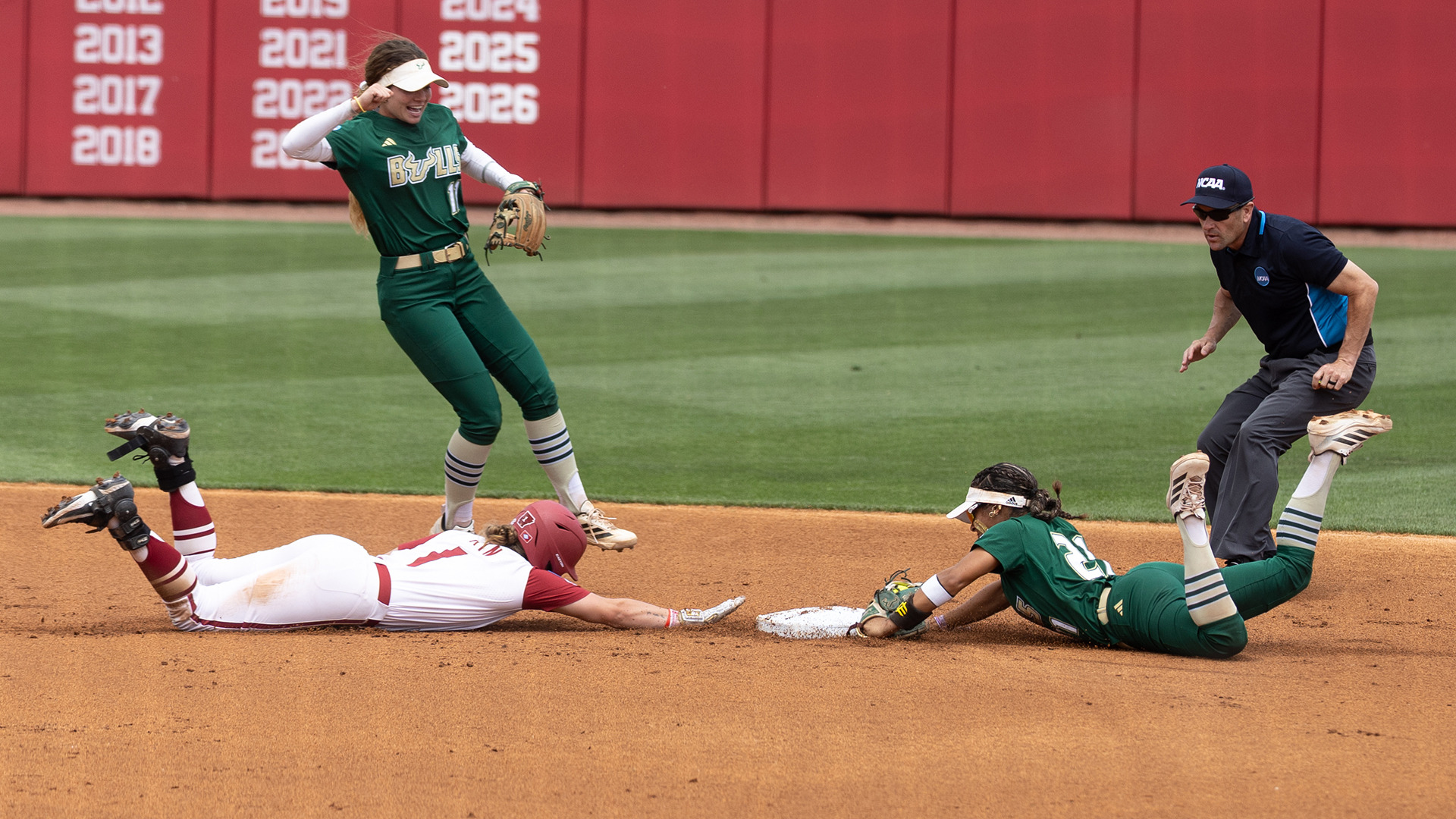 Softball's Kathy Garcia-Soto diving to turn an unassisted double play against Arkansas