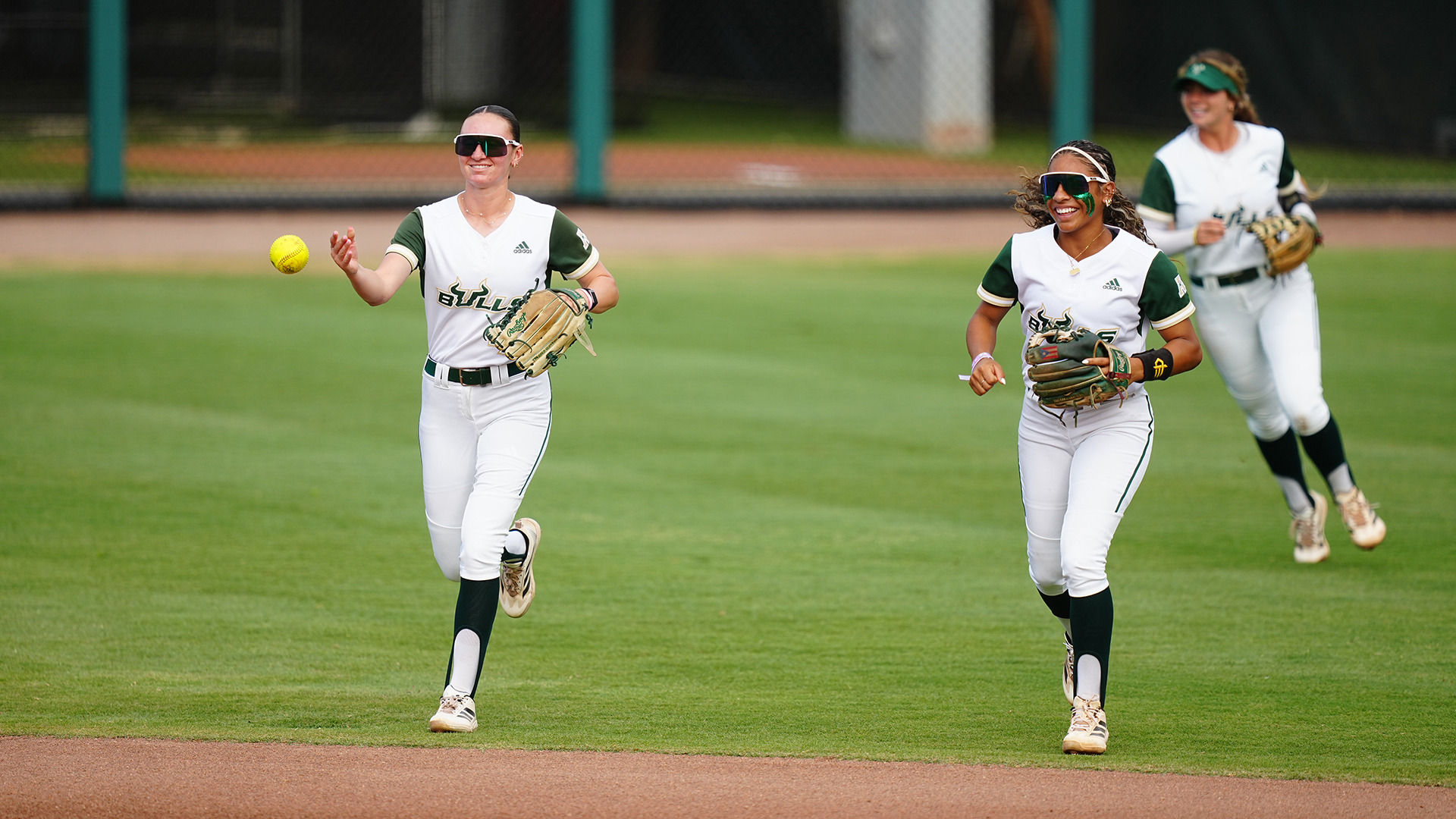 Alexa Galligani and Kathy Garcia-Soto celebrating after three outs on defense