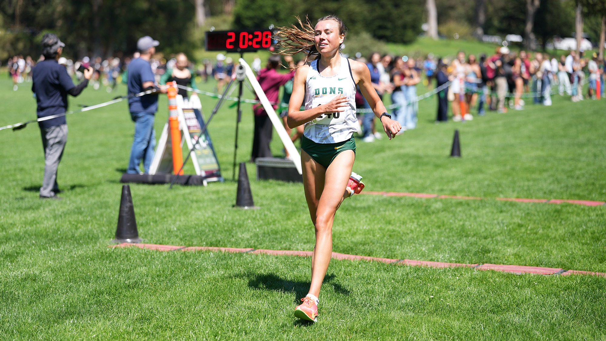Anna Büttner crossing finish line at USF Invite
