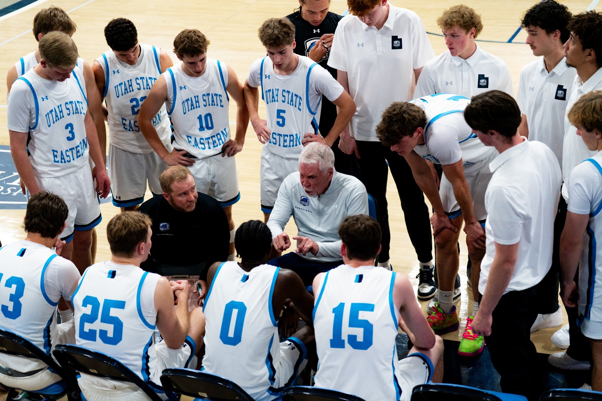 Coach Evans and Coach Ralphs talk to the team during a time out. 