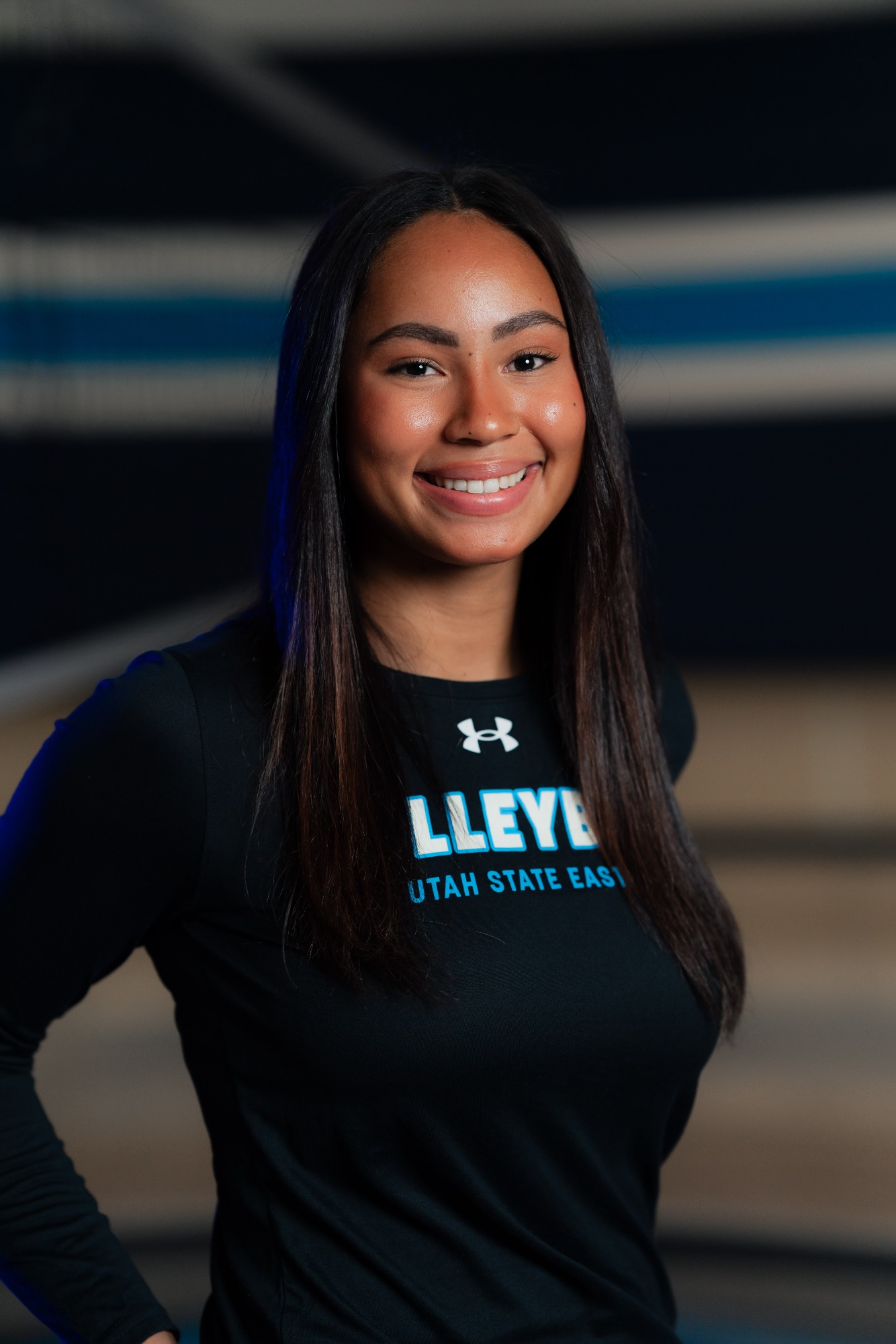 USU Eastern volleyball coach smiling for a headshot while wearing a black Utah State Eastern volleyball shirt