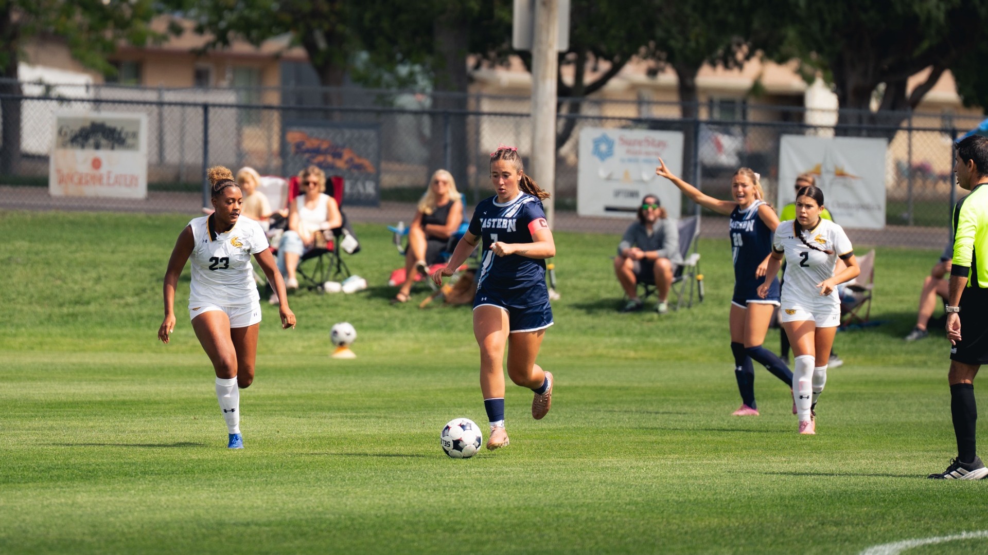 An outdoor match photo showing a Utah State Eastern women's soccer player (number 7) in a dark navy jersey with 