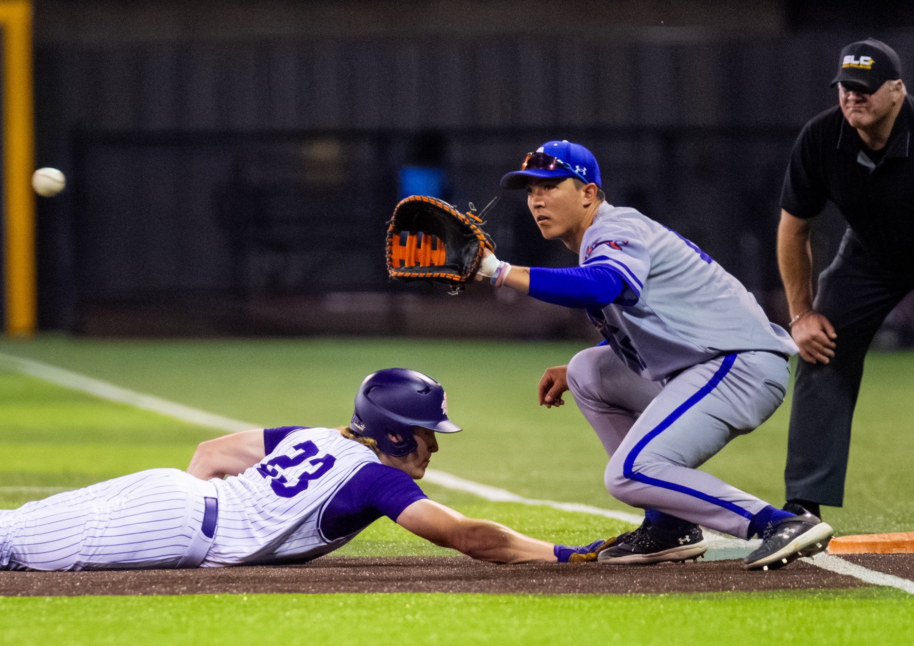 Noah Fields at first base reaching for the pick-off attemp