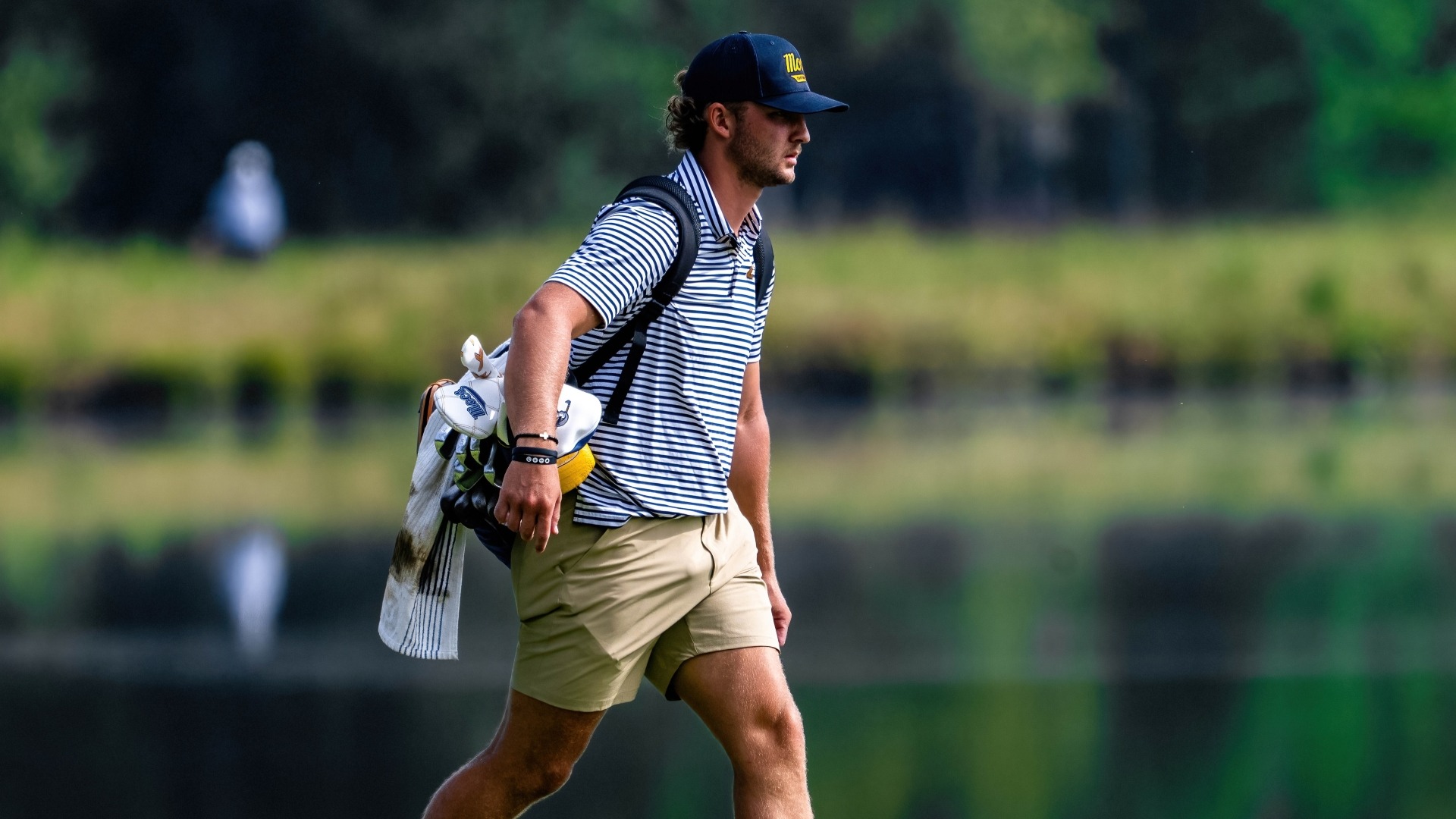Ward Harris carries his back towards the 9th hole at the Honors Course 
