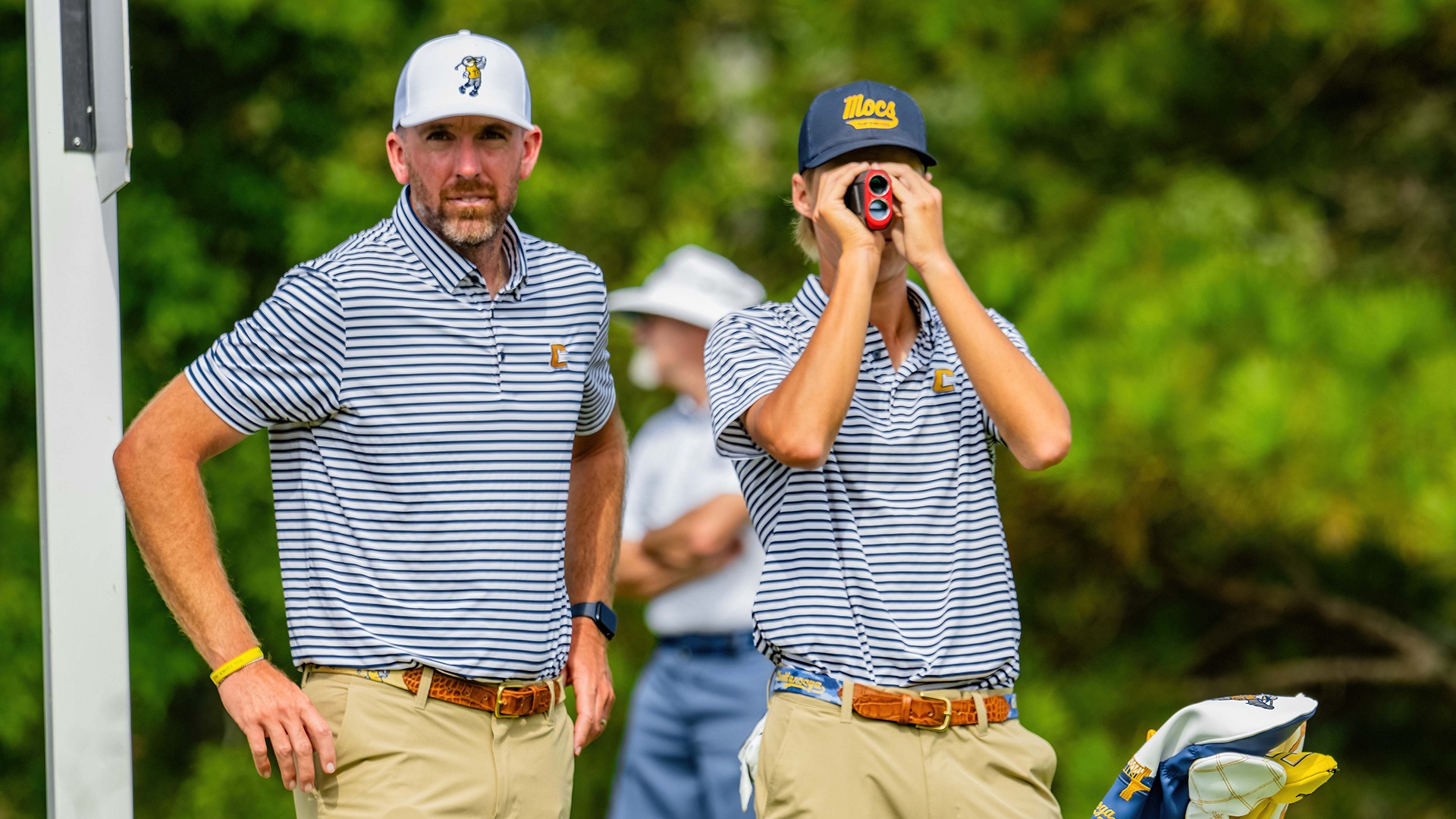Blaine Woodruff and Evan Rogers check yardage and prepare for par 3 approach