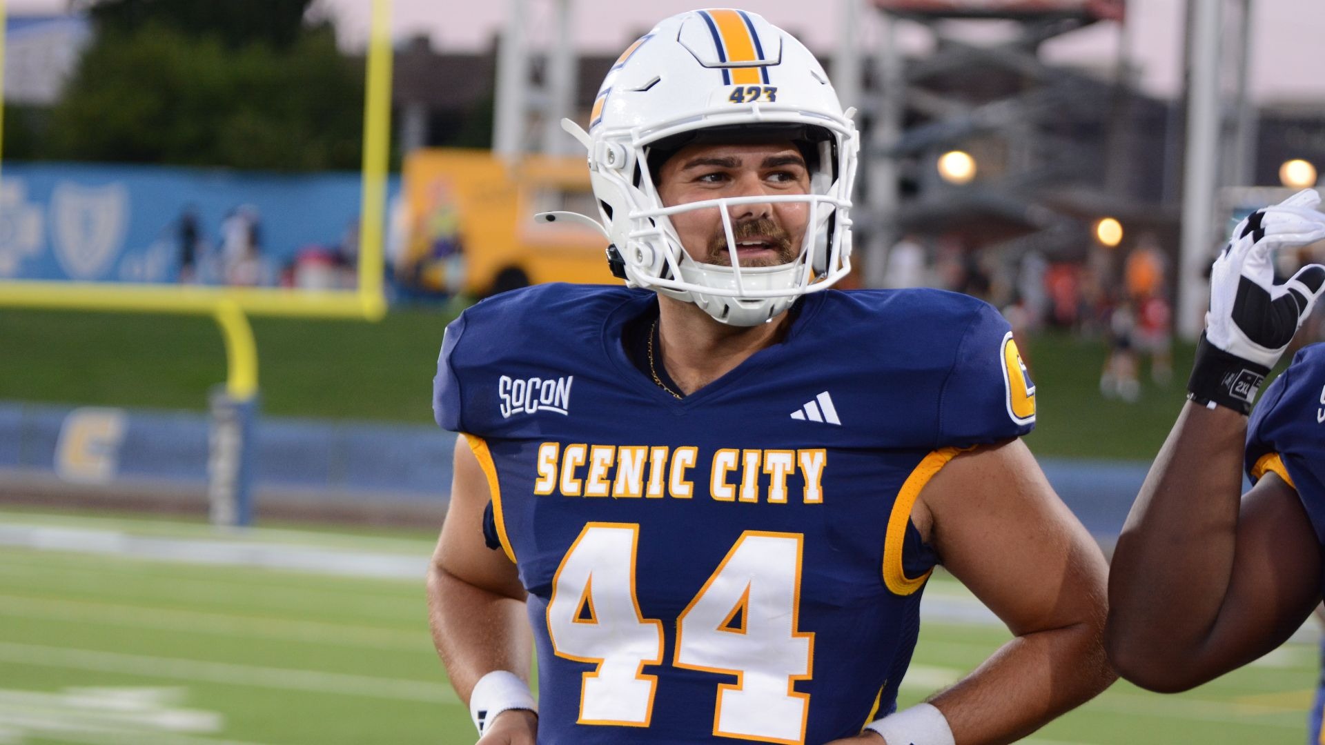 Grant Reid smiles on the sidelines waiting for his next snapping opportunity in the blowout over Stetson