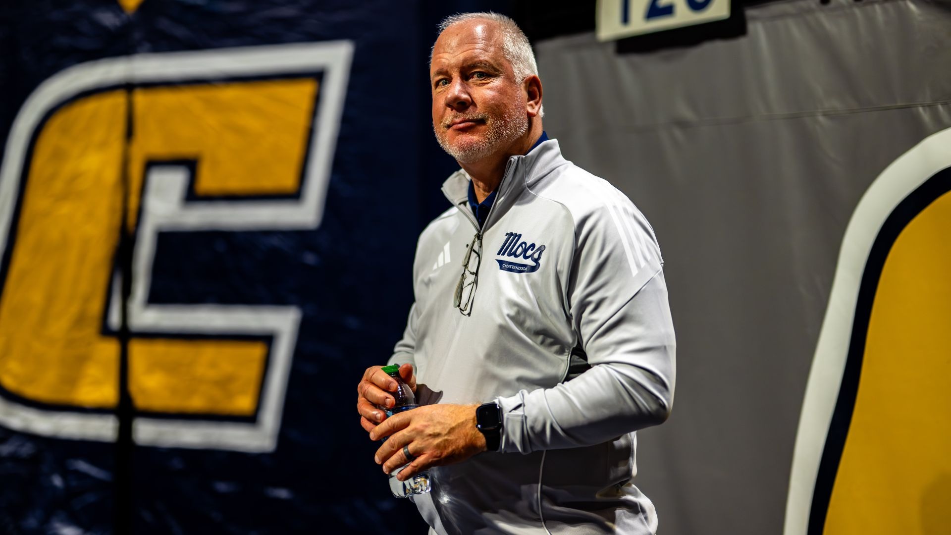 AD Mark Wharton stands courtside waiting for a timeout for a brief presentation in the Roundhouse