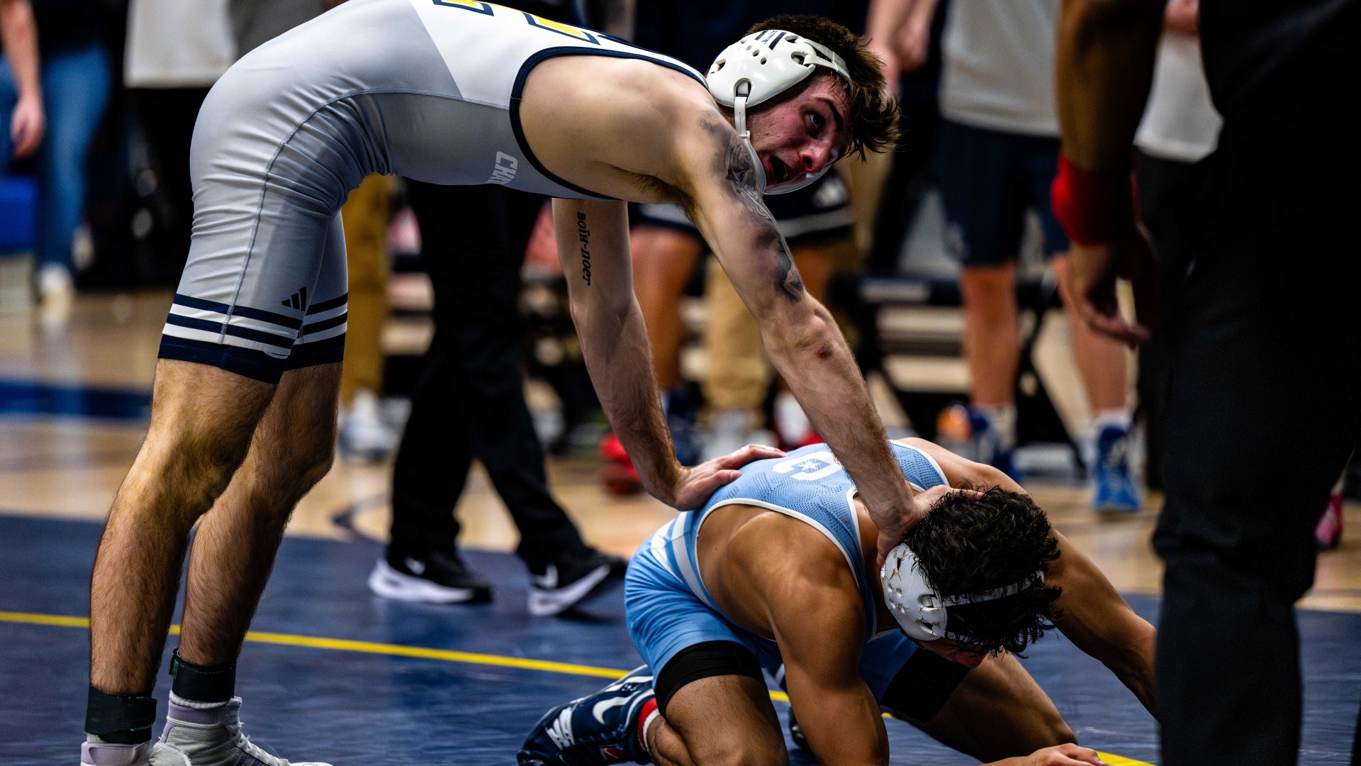 Ethan Uhorchuk pushes down on the back of a prone Citadel opponent preparing to cut him allowing an escape.