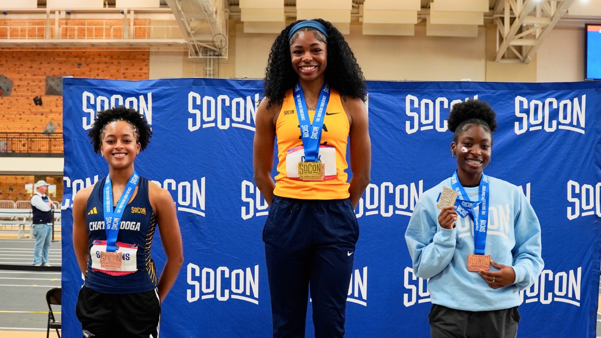 Three track athletes on the podium at the championships.