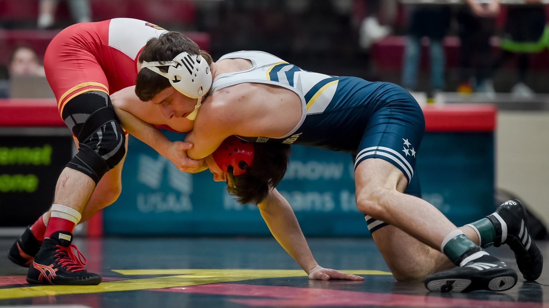 Cooper Flynn works his opponent toward the mat prior to earning a pin in the win over VMI