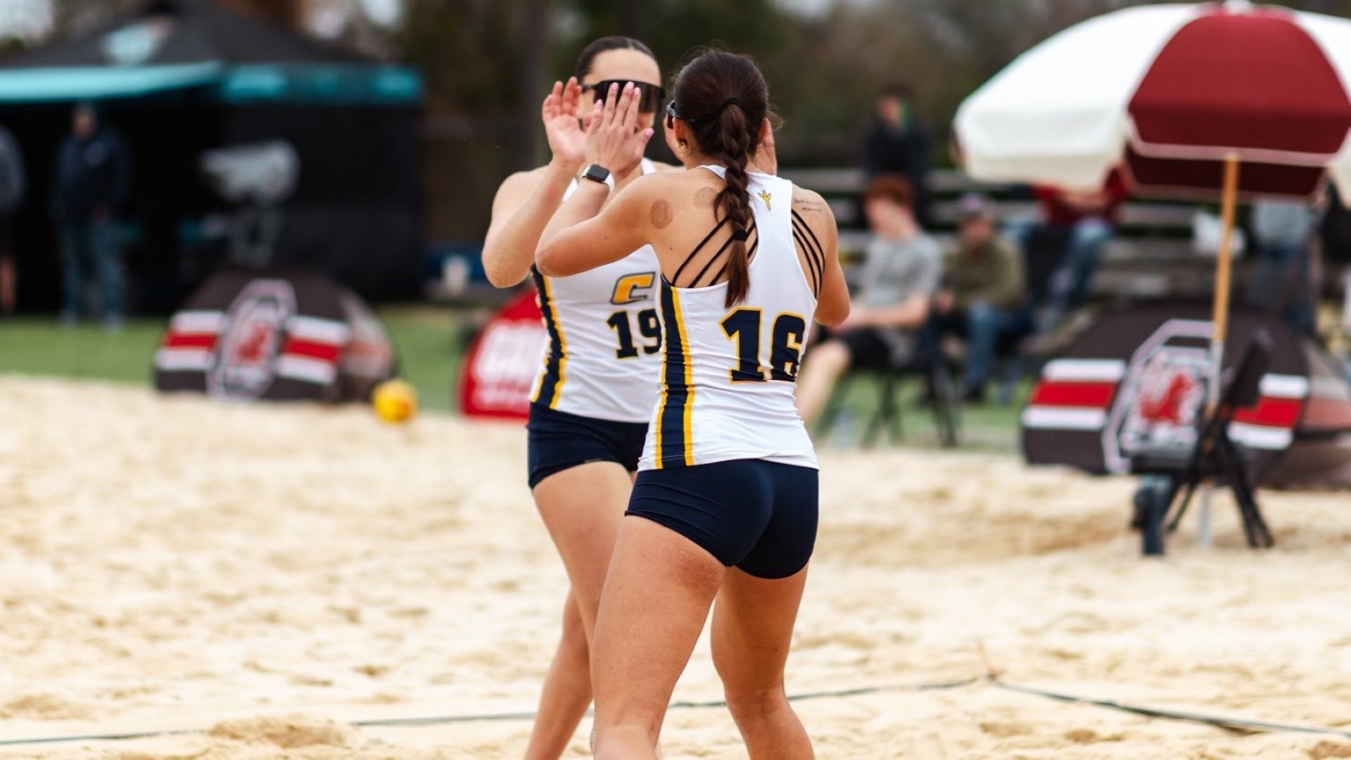Corina Vale & Julia Lawrence celebrate a winning point 