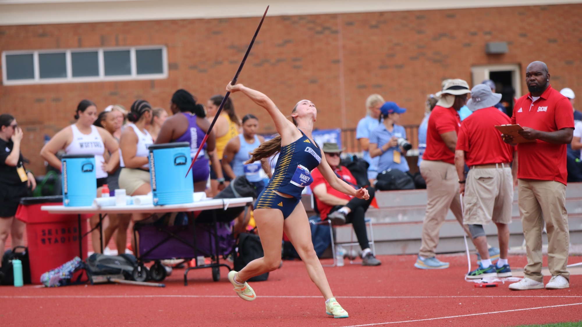 woman throwing a javelin at a track and field meet