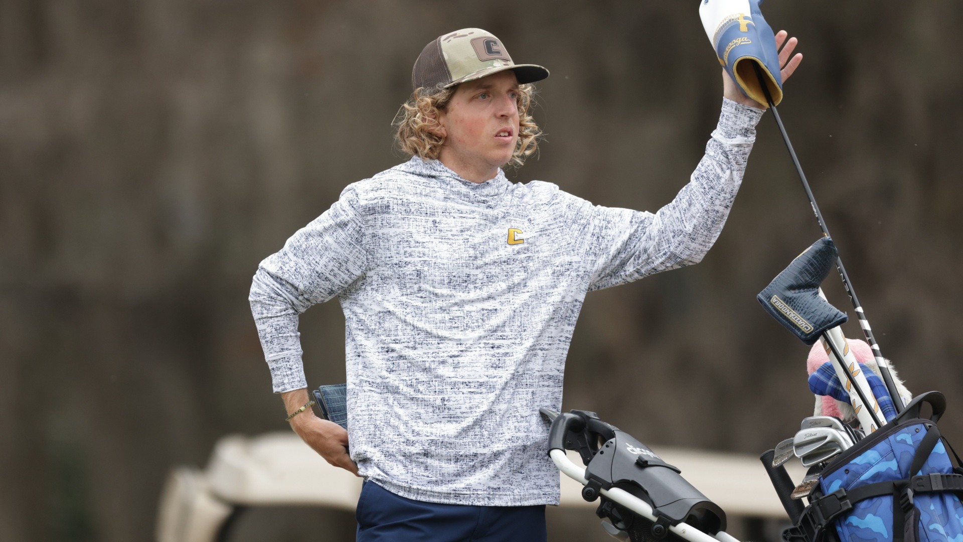 Camden Braidech looks down the fairway as he pulls his driver out of his bag at the tee
