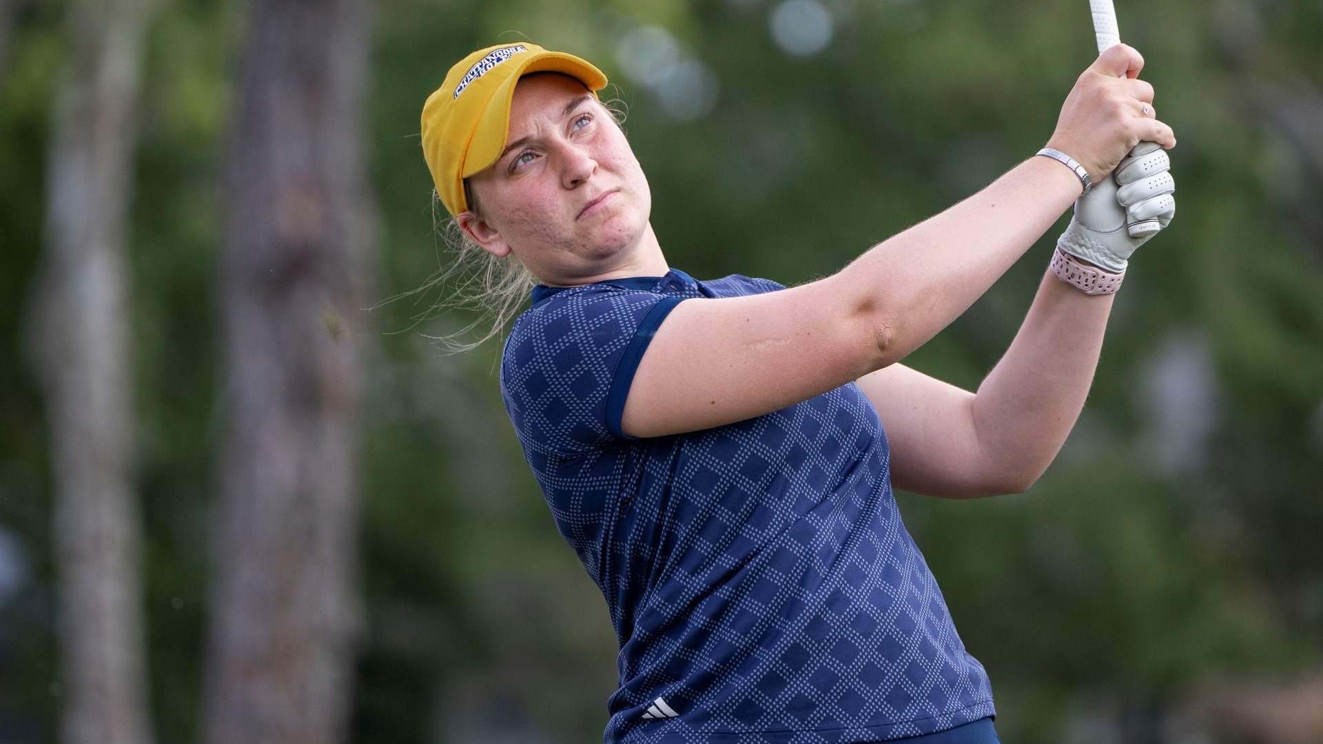 Makenzie Cooper holds her club in front aimed at the target as she follows the flight of her ball