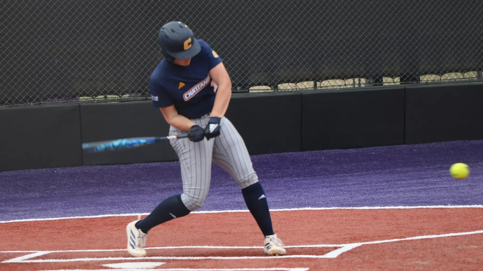 A softball player gets a hit.