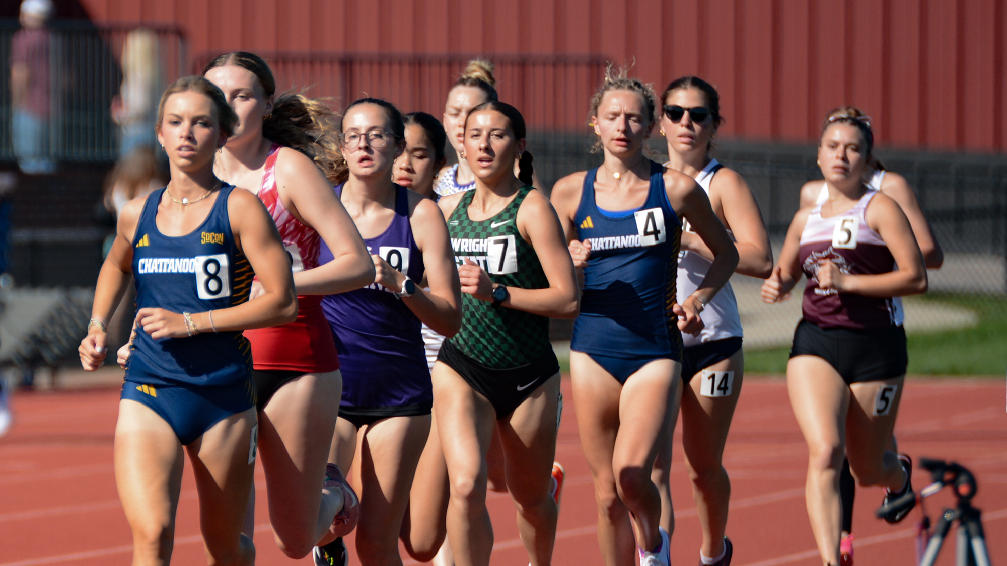 A pack of runners on the track for the 1500 meter run.