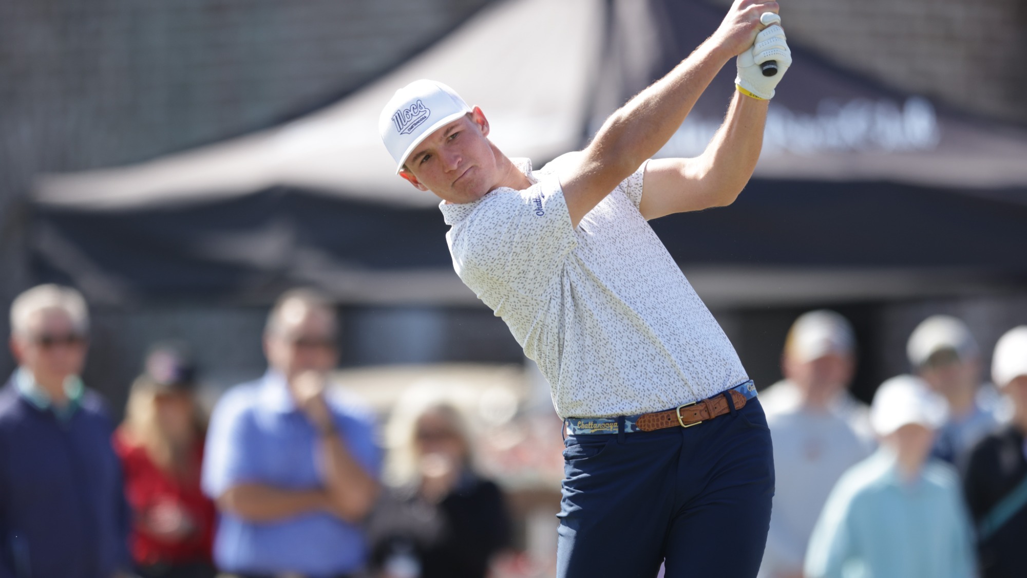 Griffin Law is finishing his swing as he levels his stare at his ball tracking the fairway
