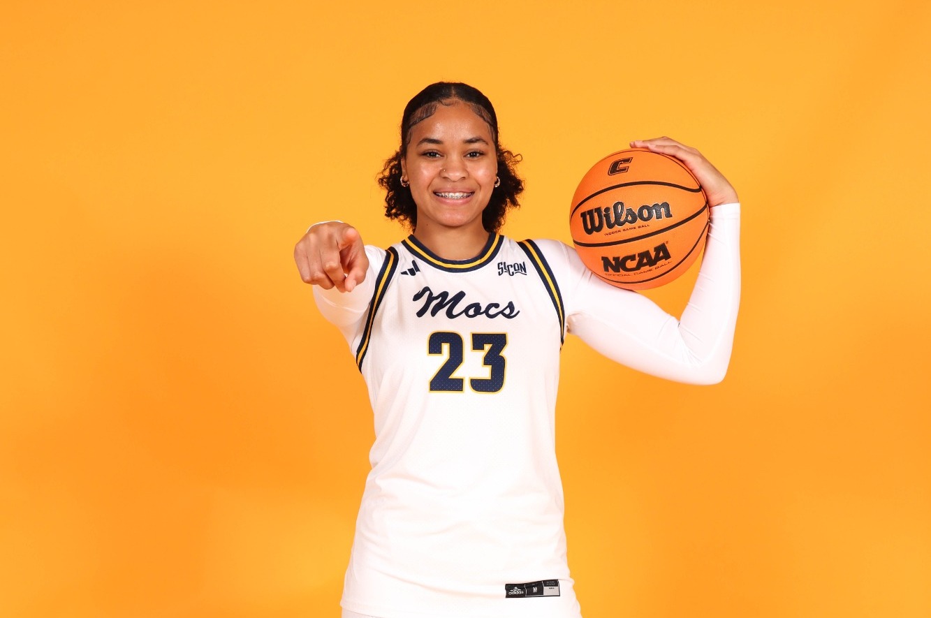 TaTianna Stovall taking a photo in a Mocs jersey on her visit to UTC