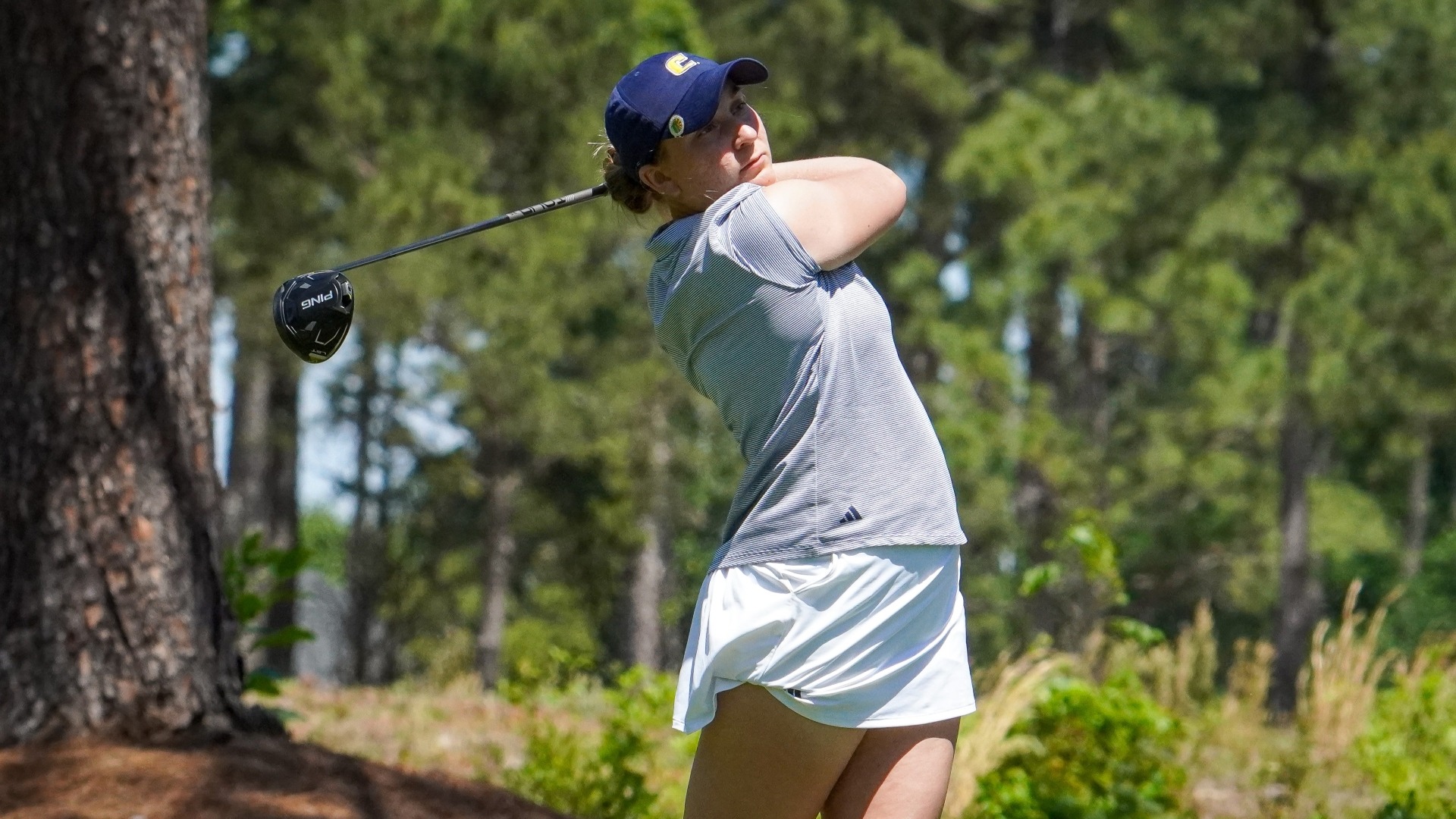 Makenzie Cooper holds her pose as she follows her drive down the fairway.