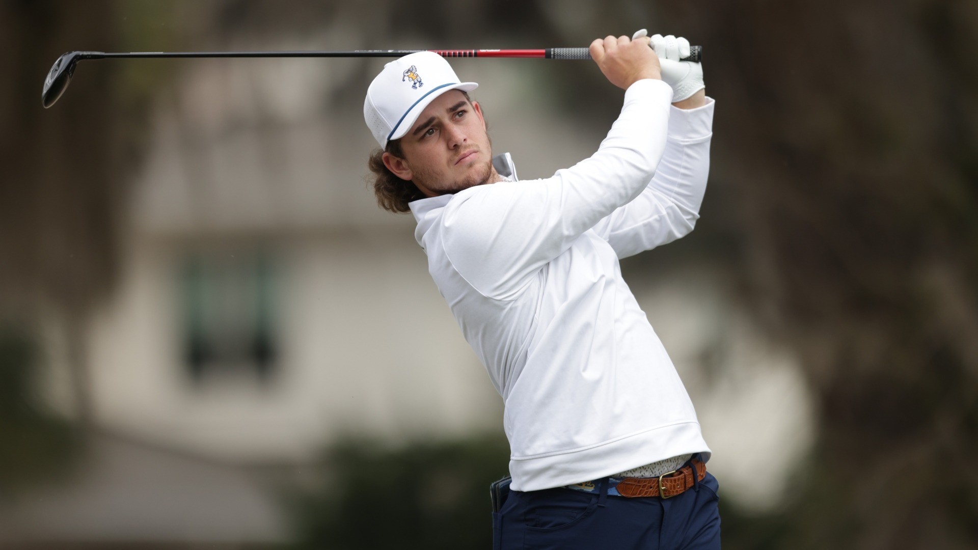Ethan Whitaker is at the top of his swing as he watches his drive track skyward towards the middle of the fairway