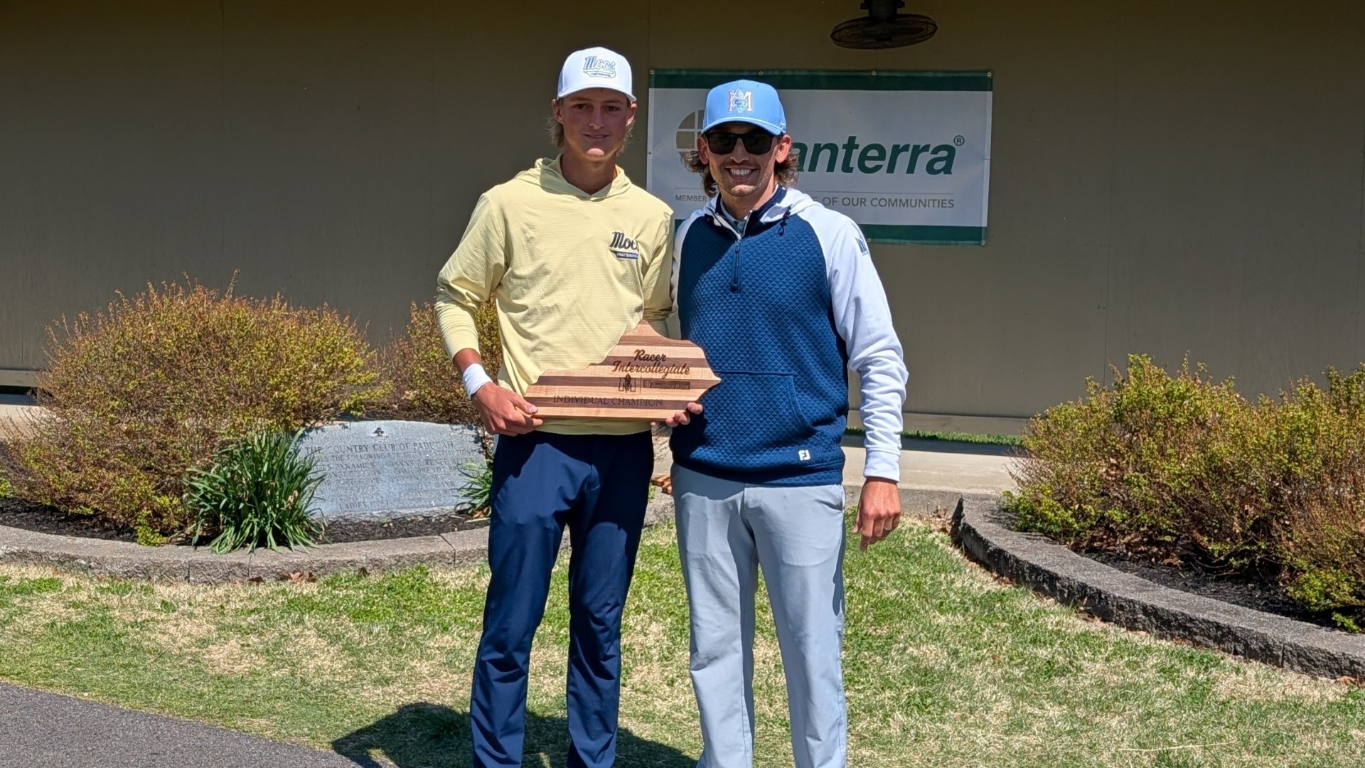 Evan Rogers accepts his winner's trophy from Murray State Coach Jacob Miller