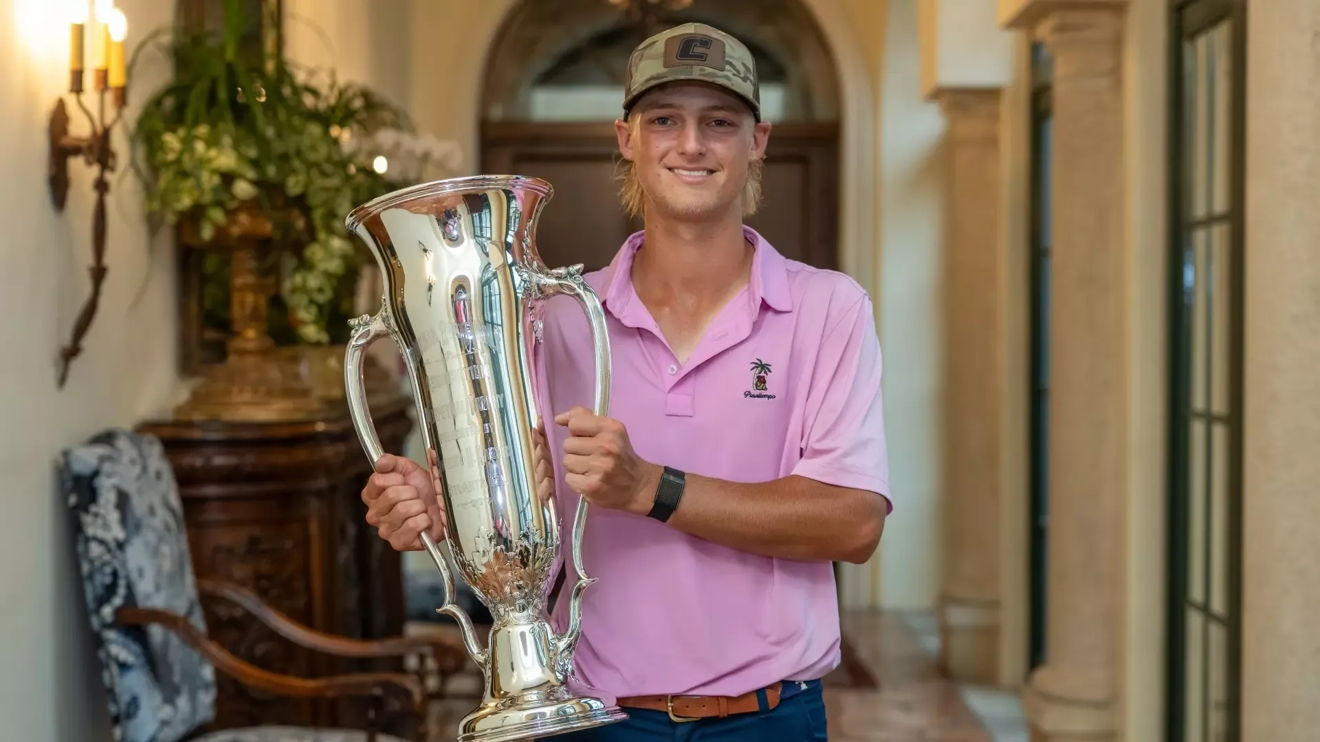 Evan Rogers proudly hoists the Georgia Am Trophy with a broad smile