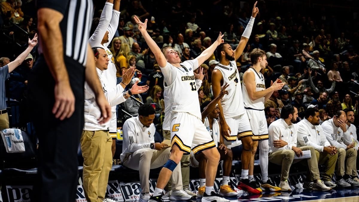 Houston Holland leads the bench celebrations after a crucial play on the court