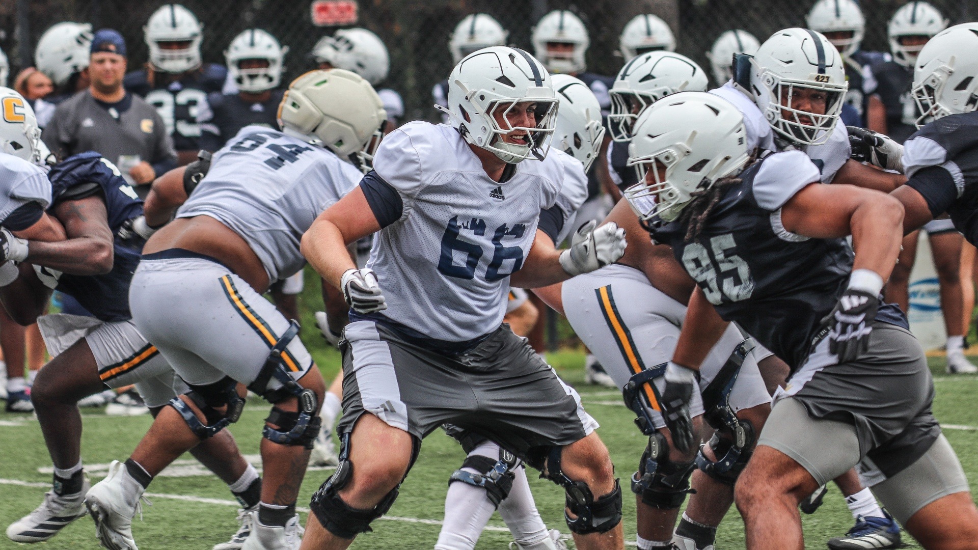 Watts Alexander drops into pass protect as Ryan Bell advances from the edge.