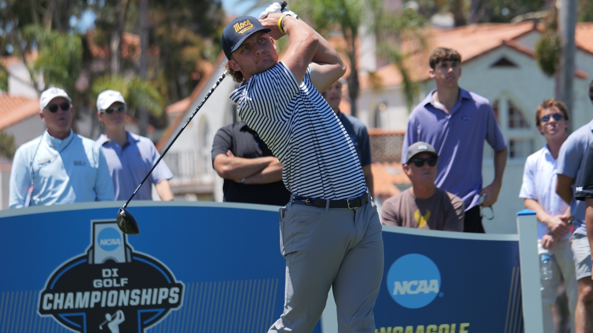 Ward Harris completes his swing from the tee with a large following at the NCAA Championships