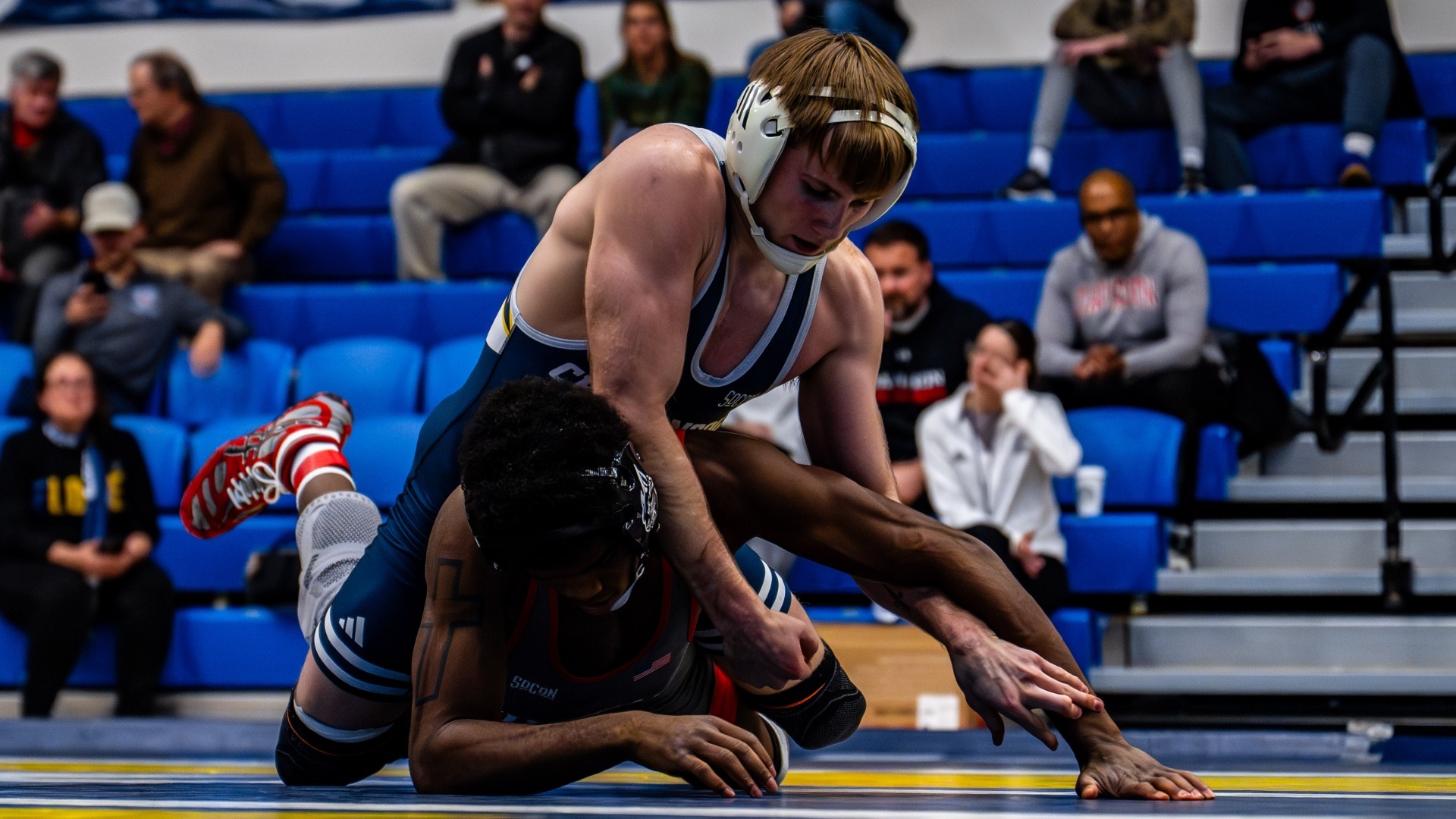 Hunter Mason is in dominant position on top staying high and controlling his opponent's wrists as he's face down on the mat.