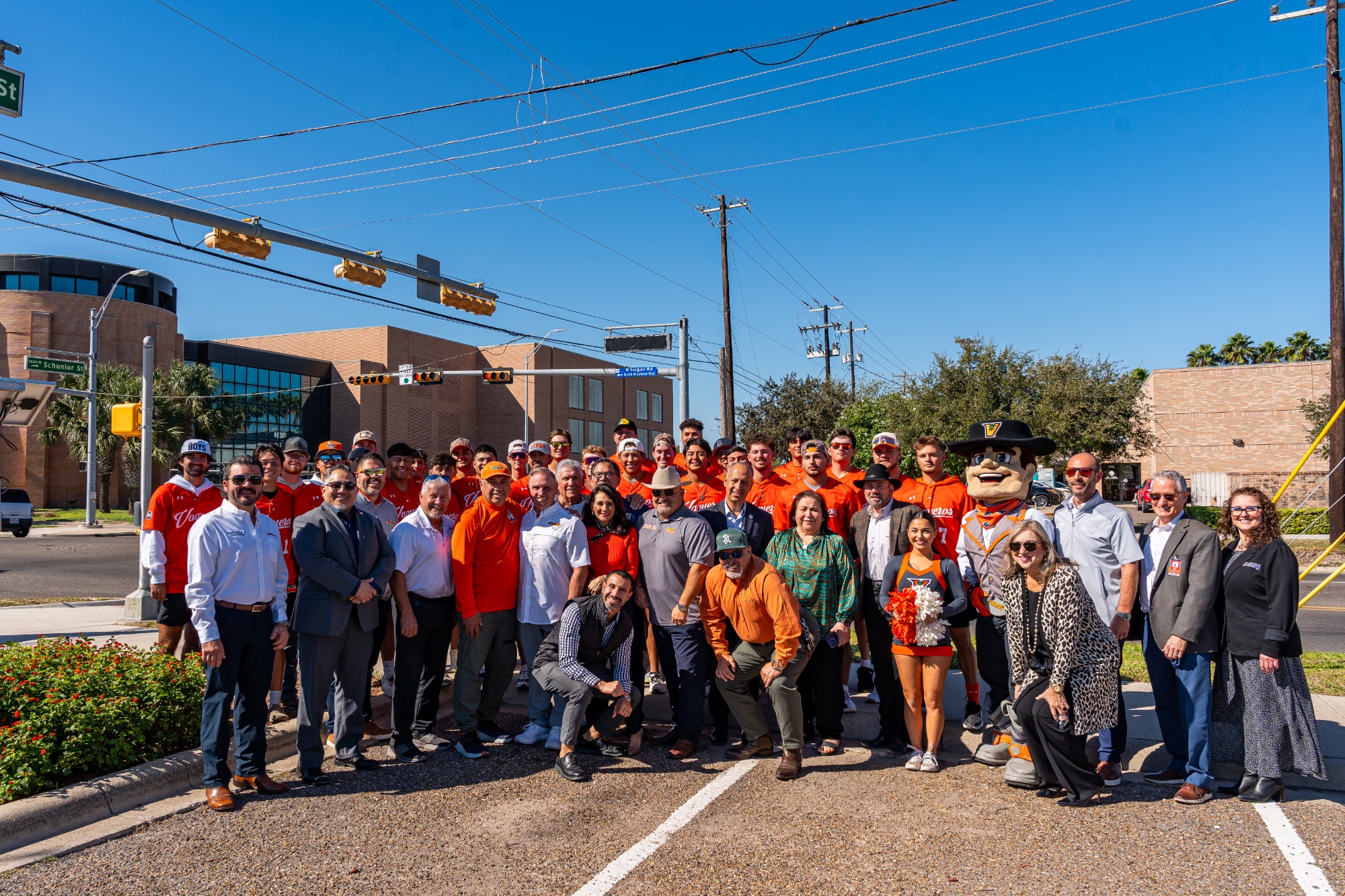 Group photo in front of the Coach Al Ogletree Way sign