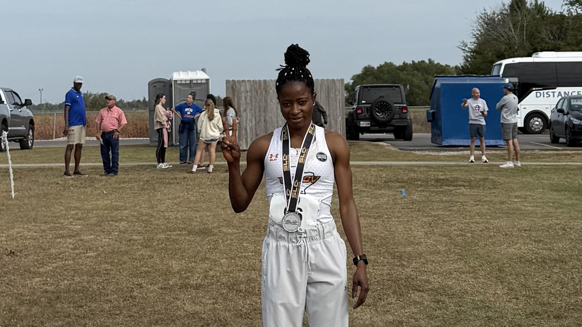 Photo of N Vanee Anchike at finish line with all-conference medal