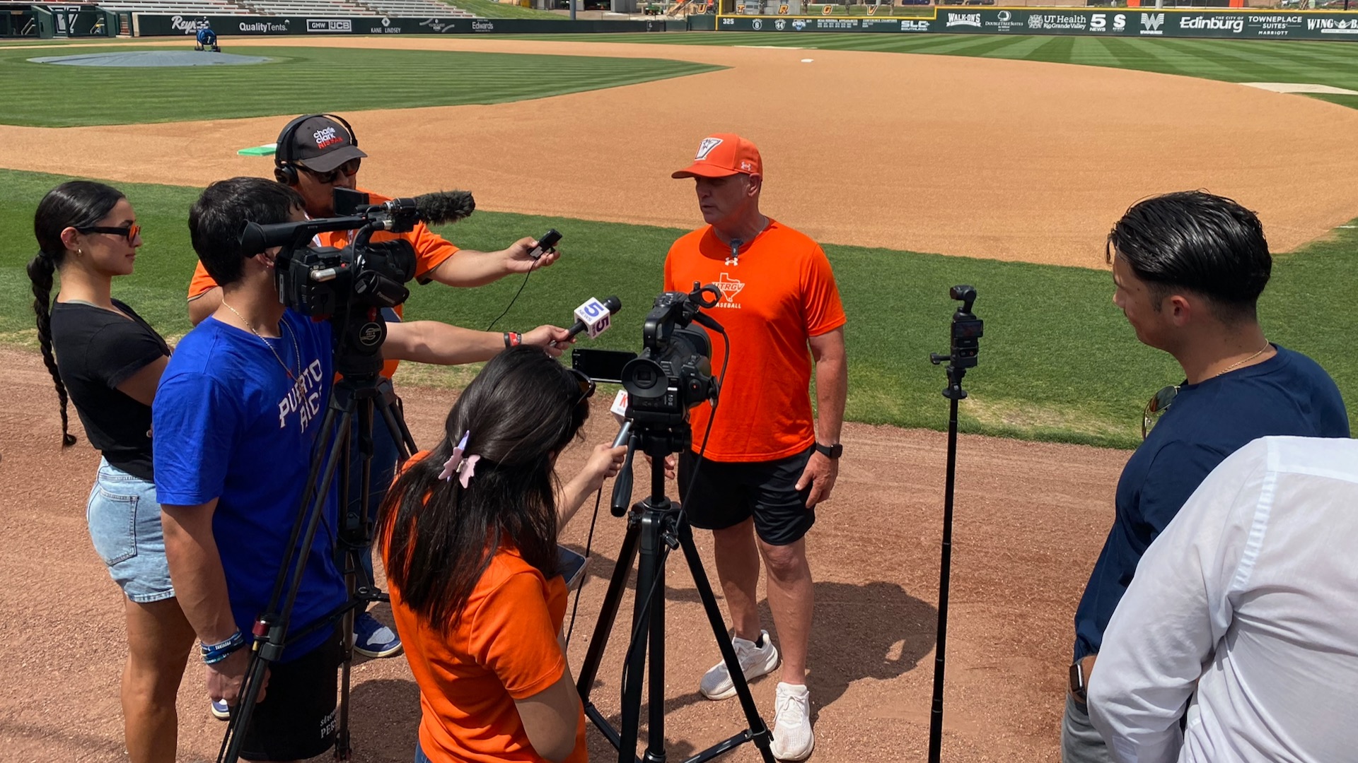 Photo of UTRGV Baseball head coach Derek Matlock addressing media on the field at UTRGV Baseball Stadium