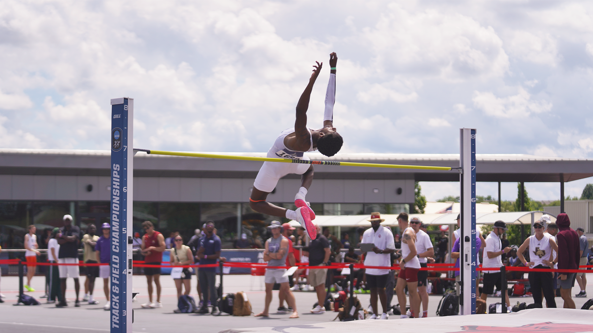 Image shows Antwoine Warren jumping over the high jump bar in a white UTRGV track & field uniform at the NCAA West First Round.