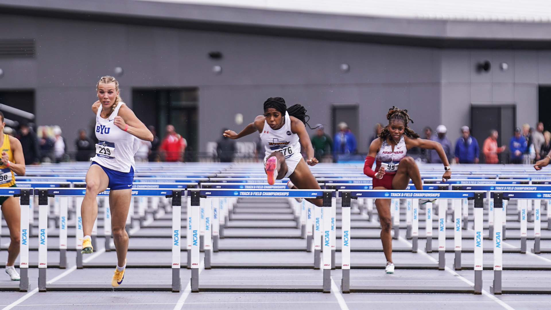 Dior Williams is seen jumping over the last hurdle in the women's 100-meter hurdles race.