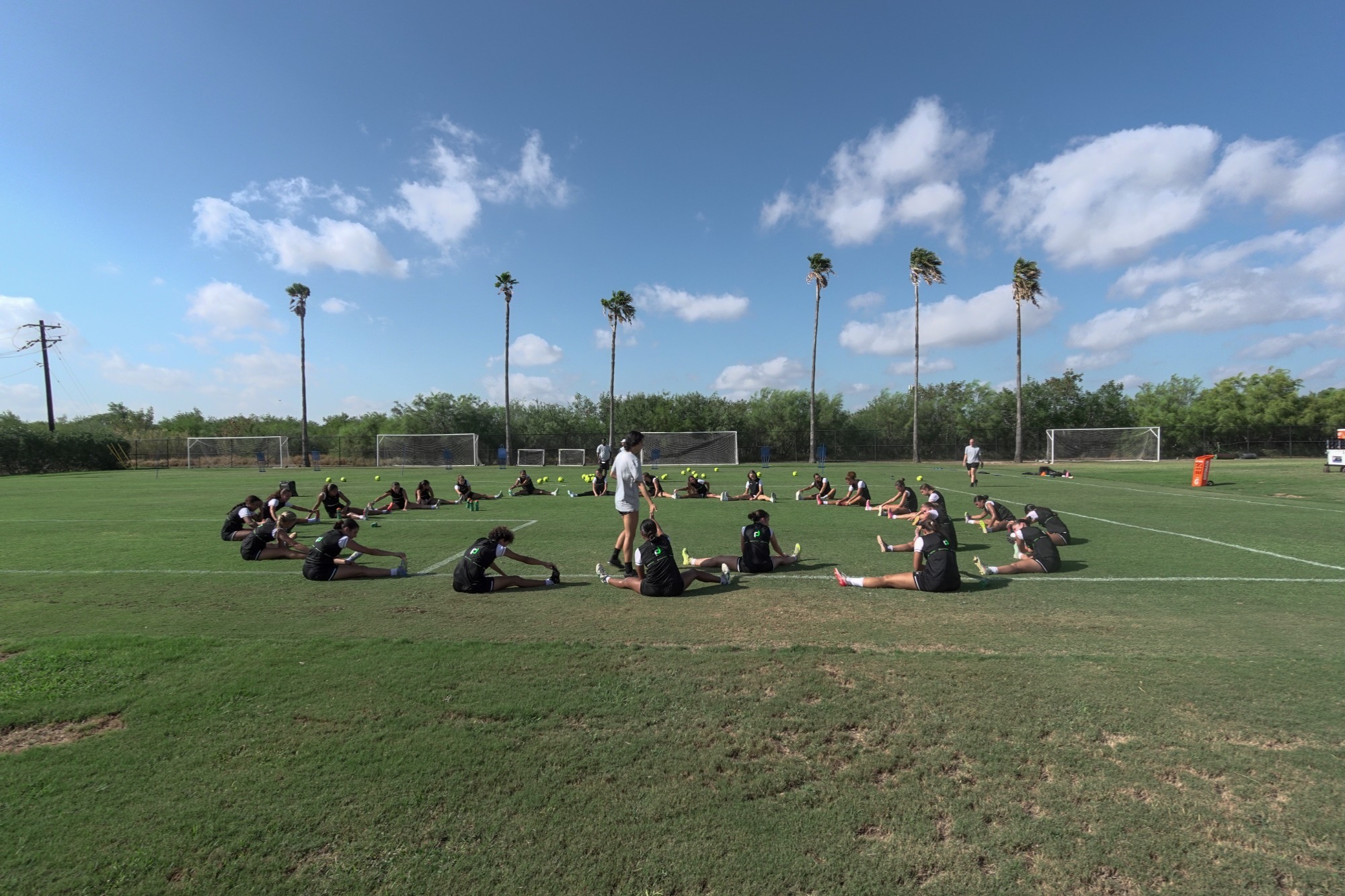   UTRGV Women's soccer stretching during practice  