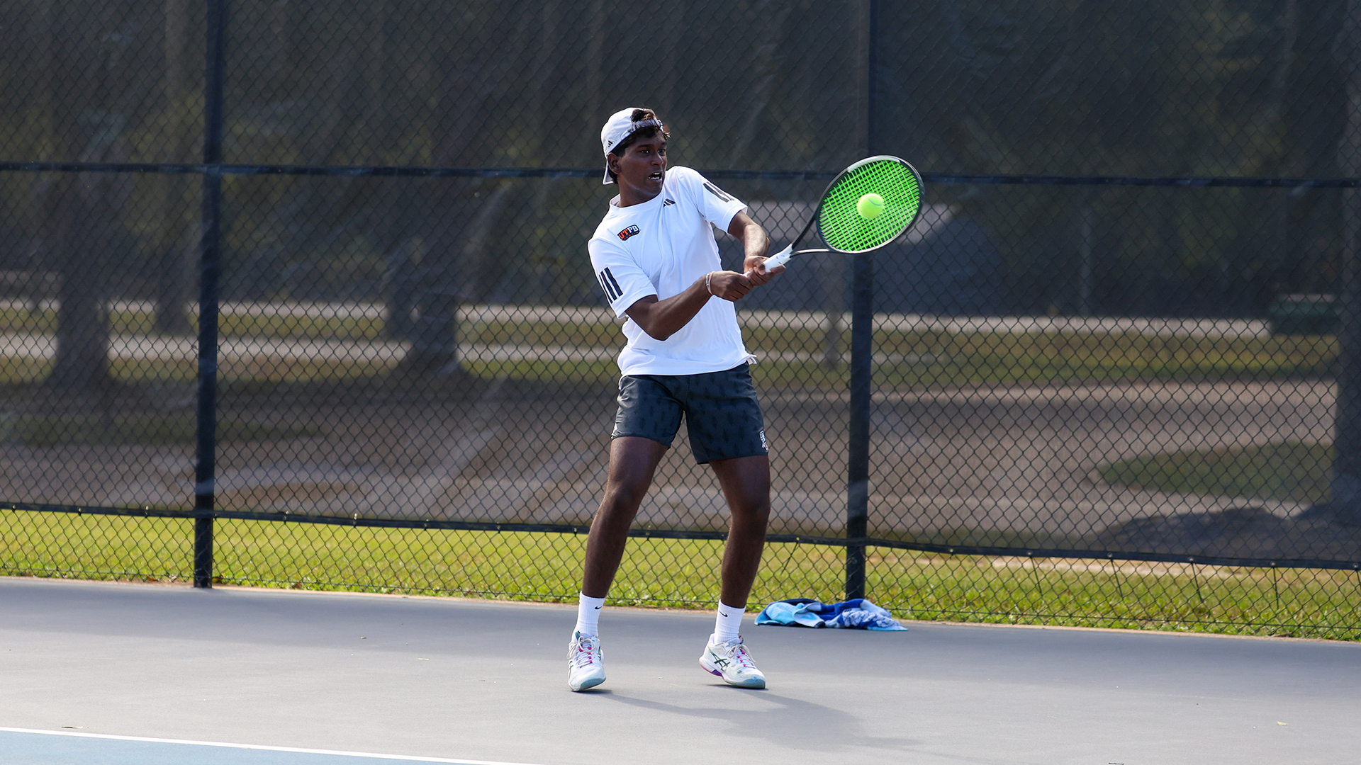 Nehal Naidoo backhands the ball