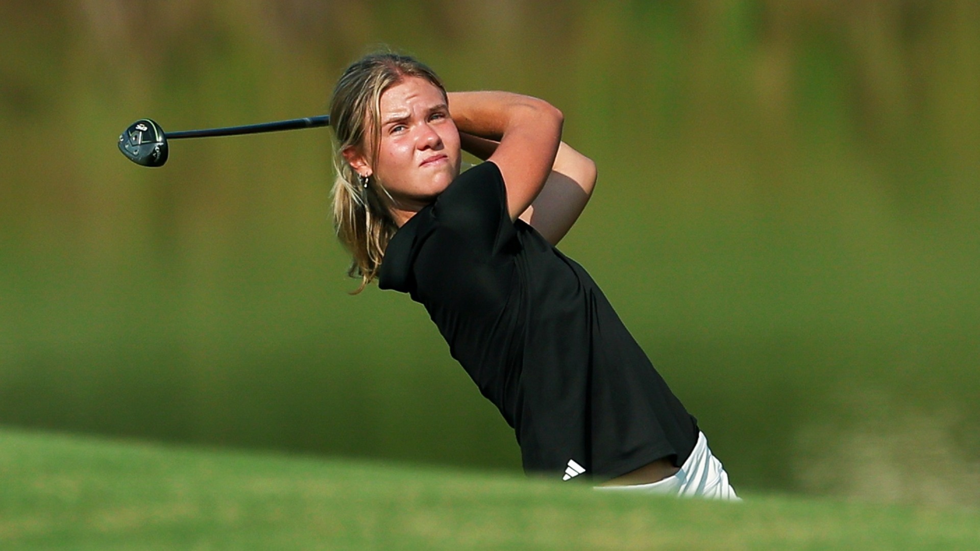 Martha Laremark hits an approach shot at Hollytree Country Club.