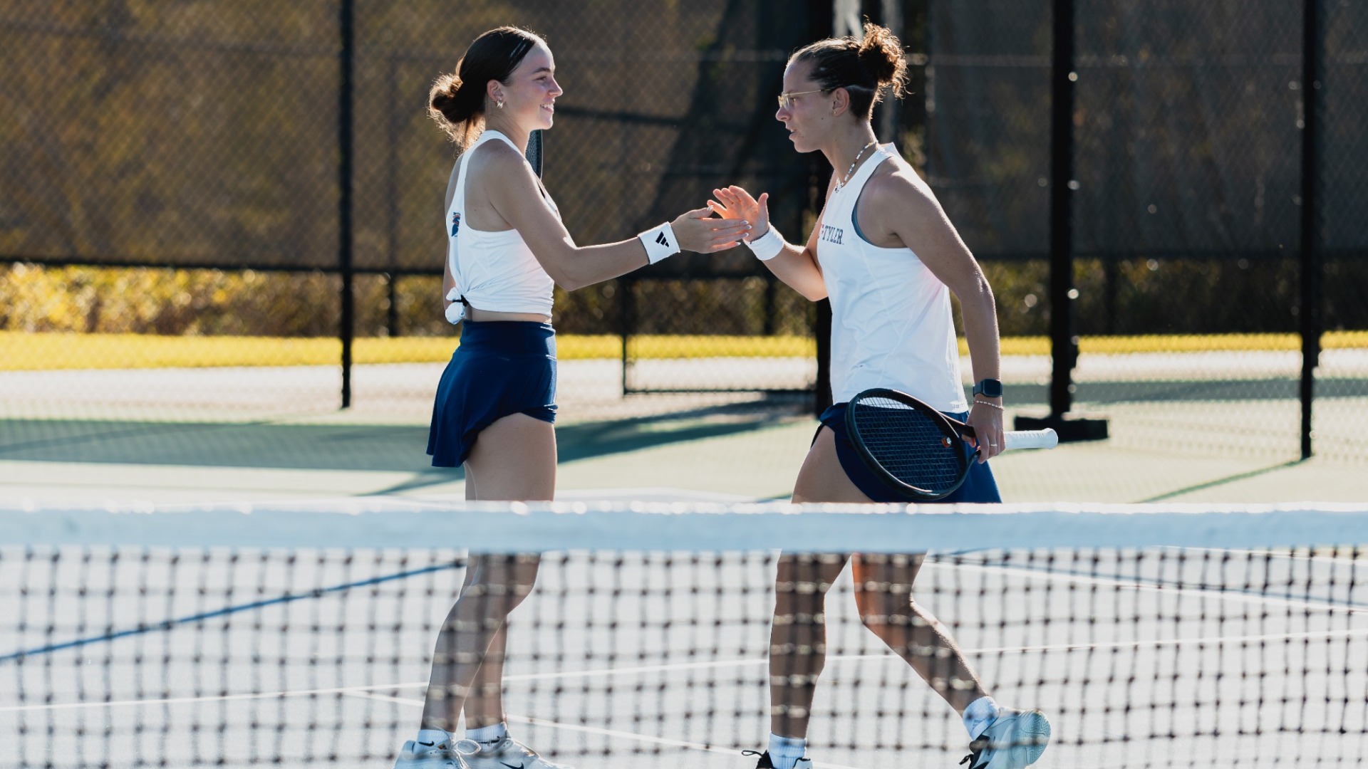 Natalia Gorzny and Yona Bancarel go for a handshake at the ITA Cup in their first round match.