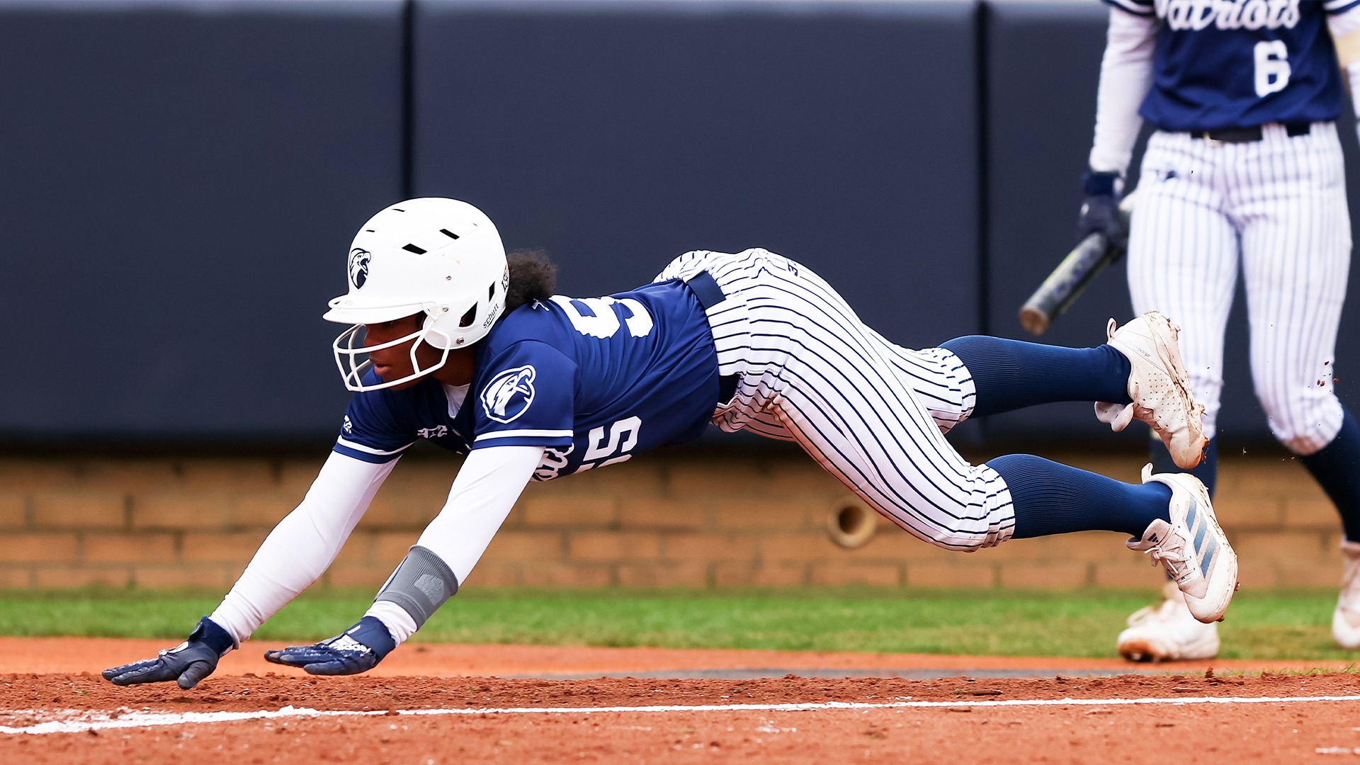 Keona Wells slides headfirst into home.