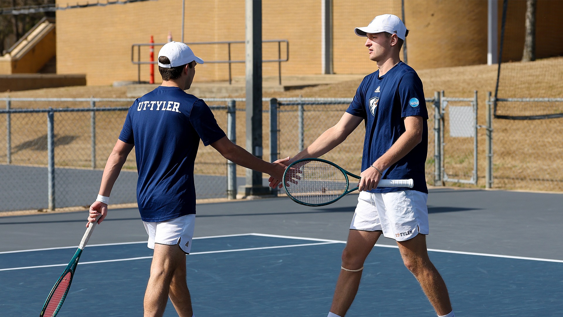 Trevor Short and Job Japelj high five after a point against Jacksonville College