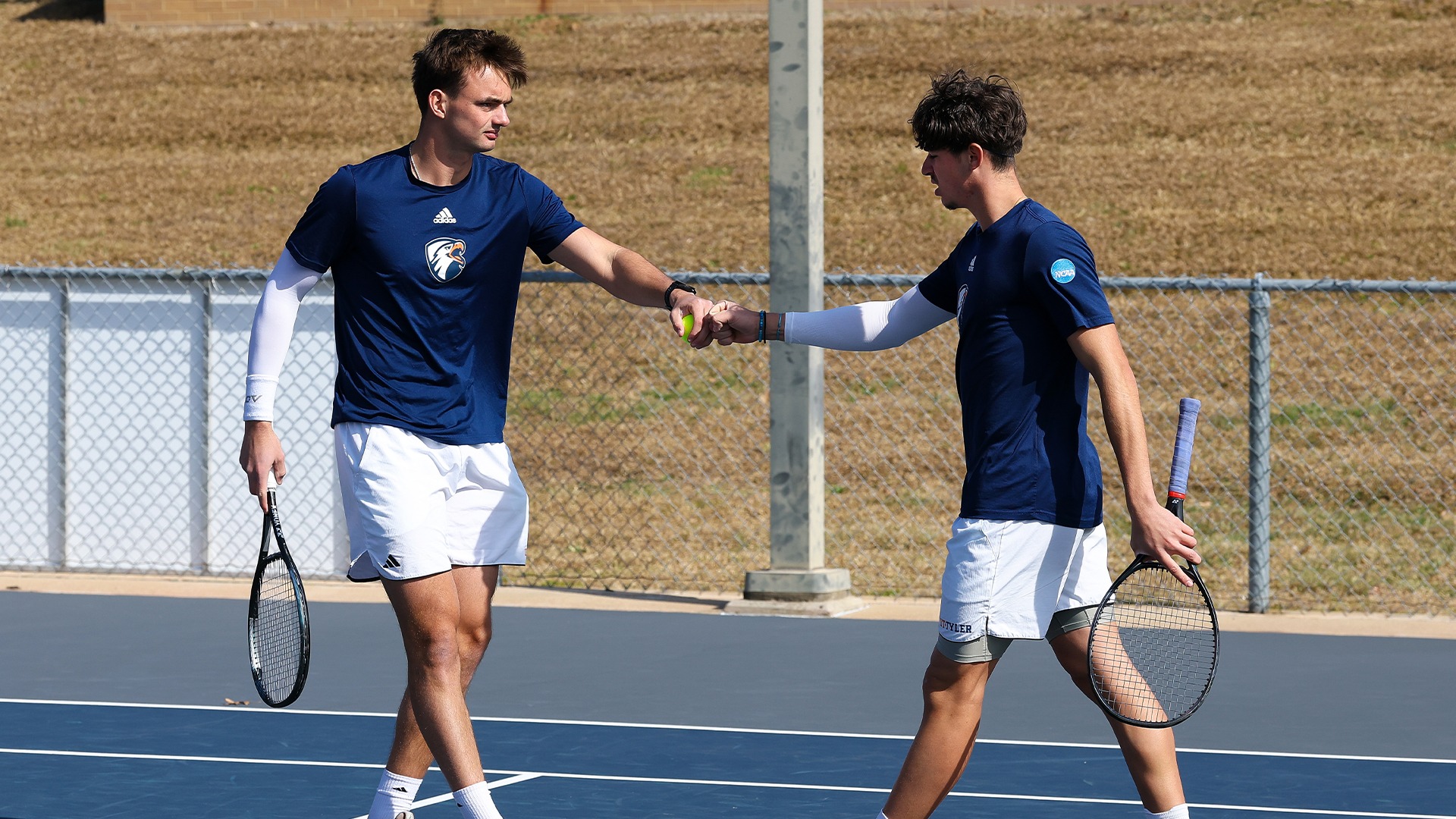 Carel Wessel and Malo Poulesquen fist bump against Jacksonville College.