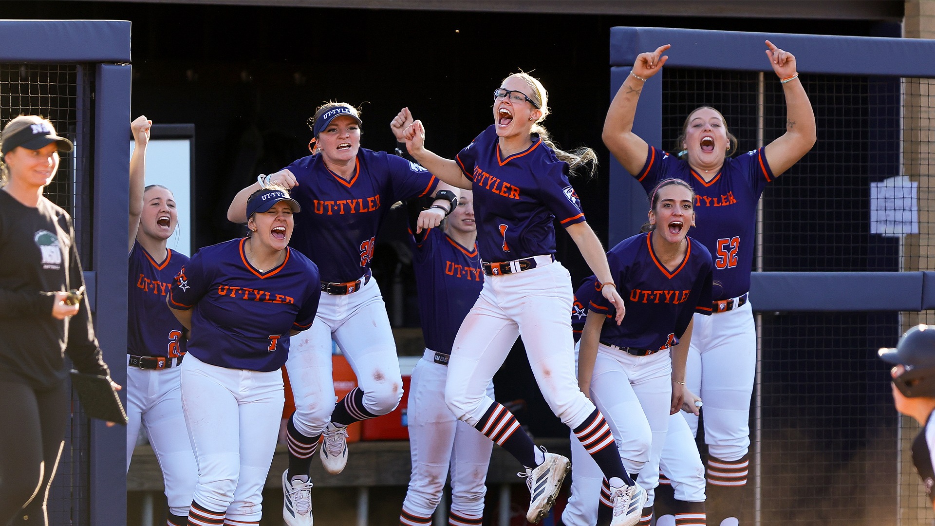 The Patriots bench celebrates a big play against Northeastern State