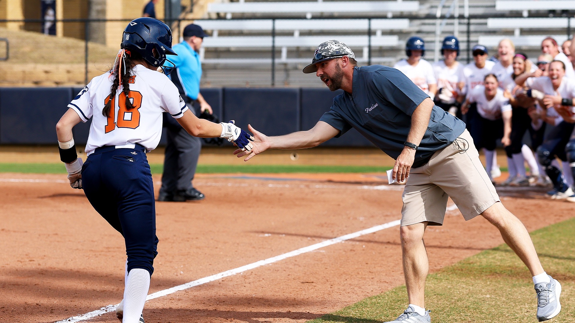 Layne Reh shakes Jason Miller's hand after a two run home run against New Mexico Highlands