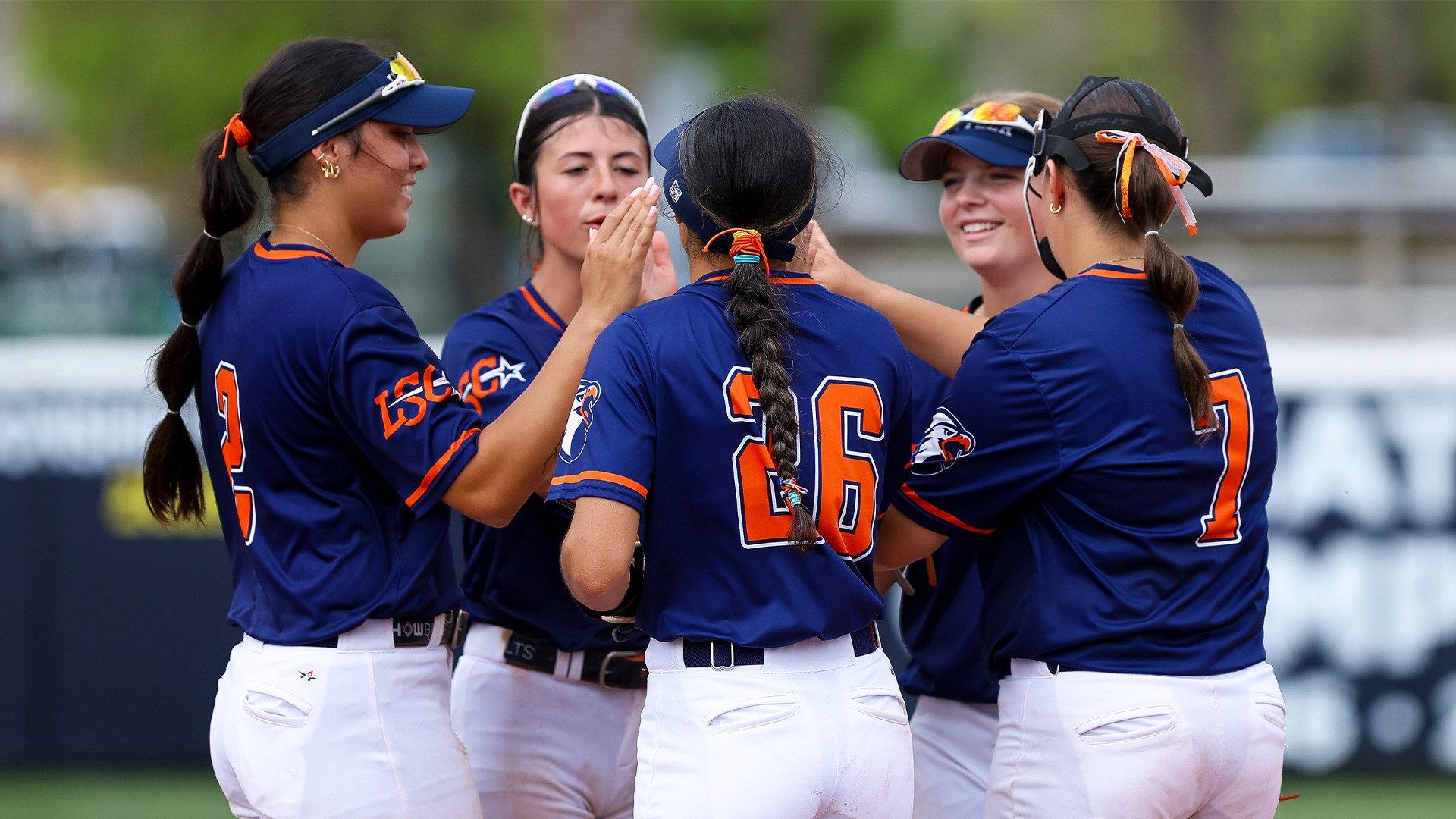 The UT Tyler infield gathers around Alli Kimball to start an inning.