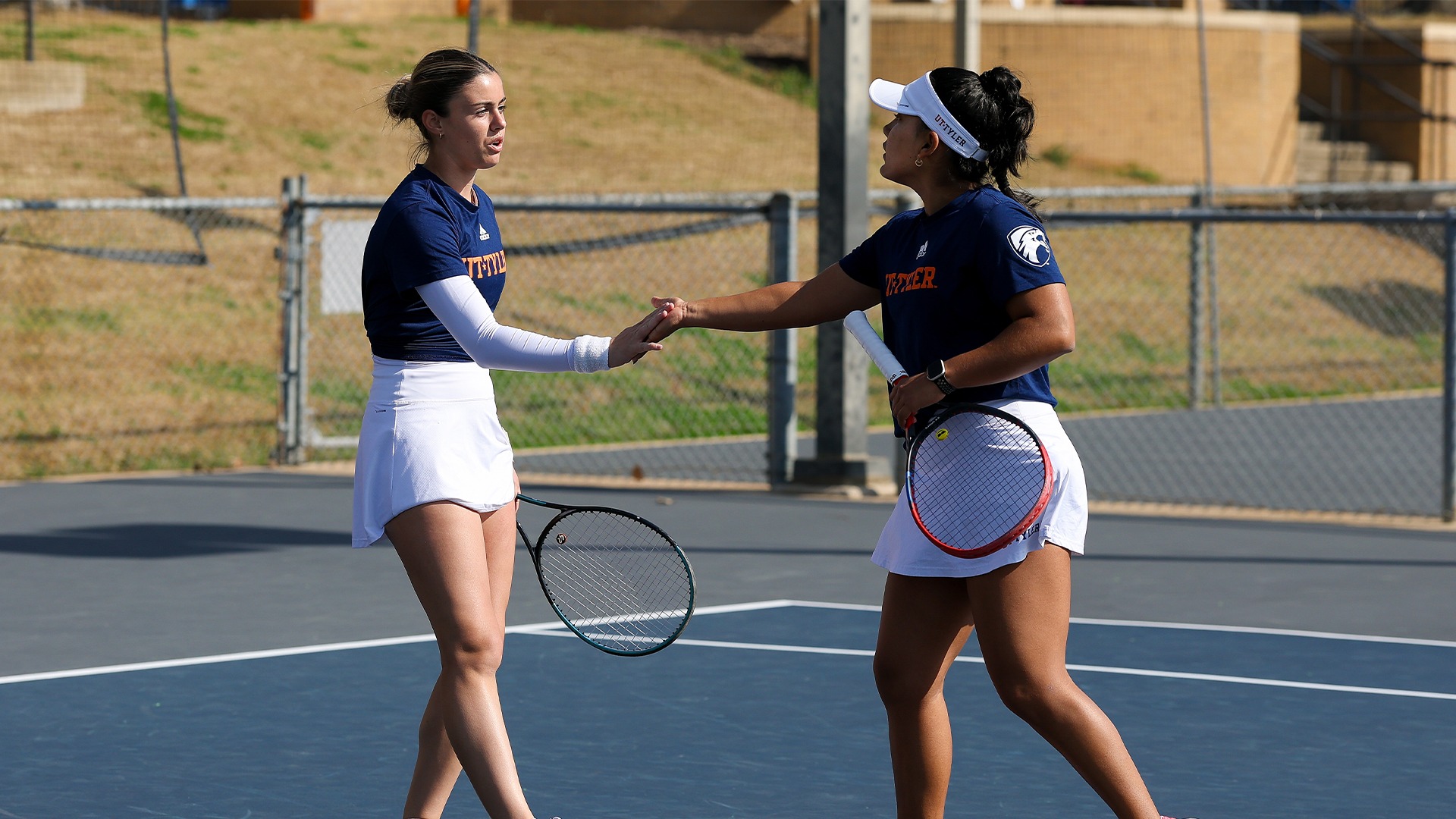 Maria Antonio Ortega and Paula Castellanos high five after a point.