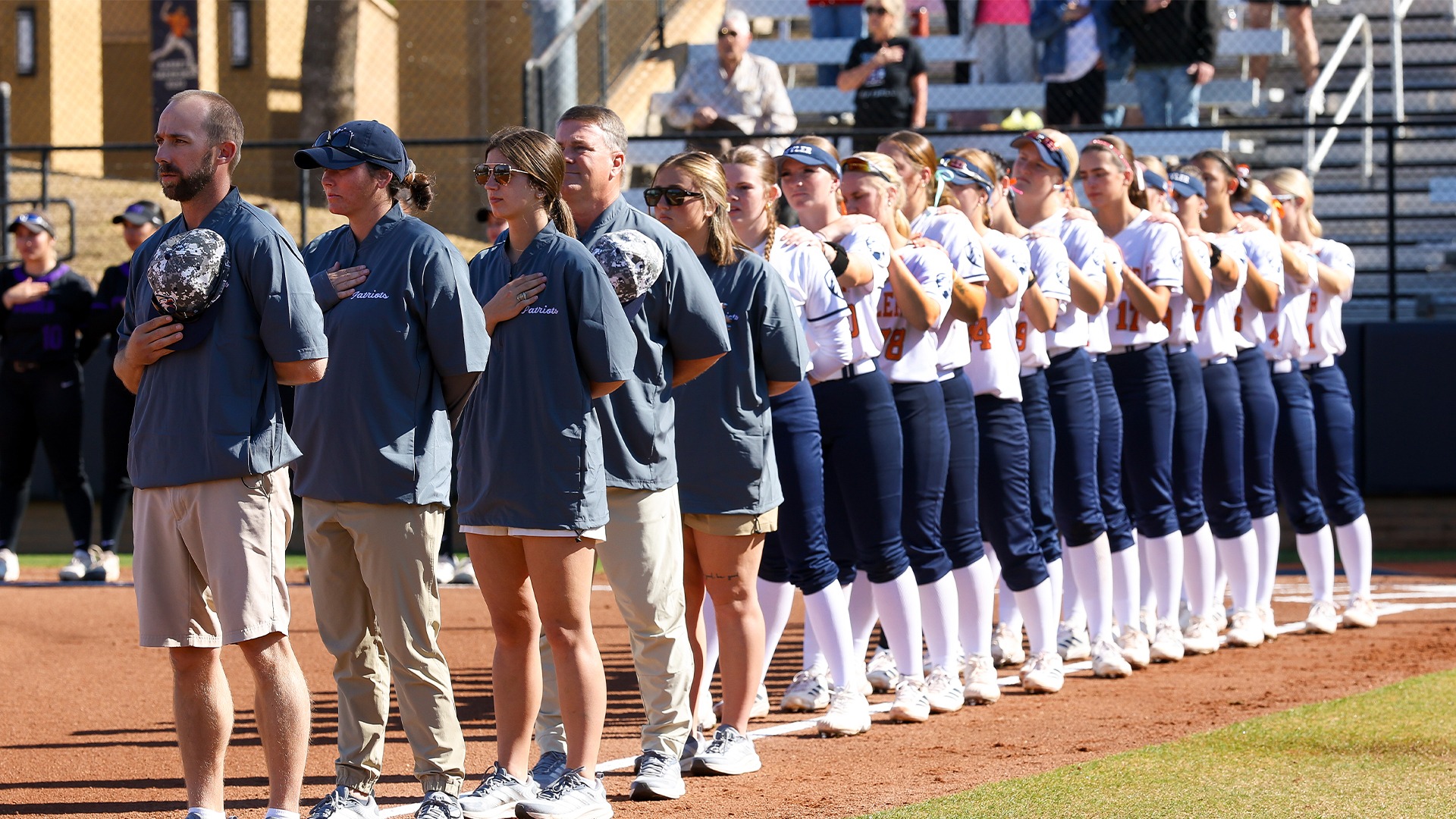 UT Tyler softball stands for the national anthem against New Mexico Highlands