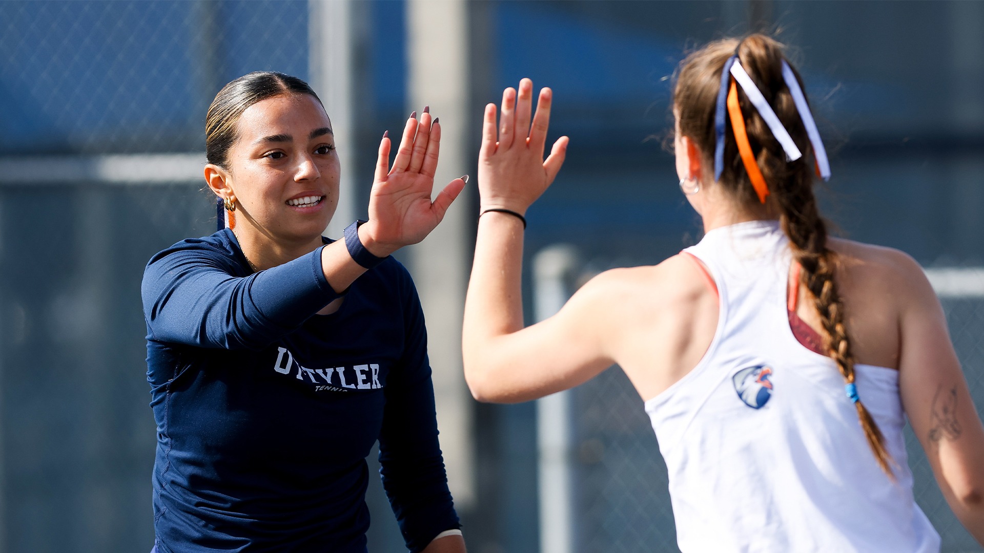 Carla Rodier and Maria Antonio Ortega high five after a point.